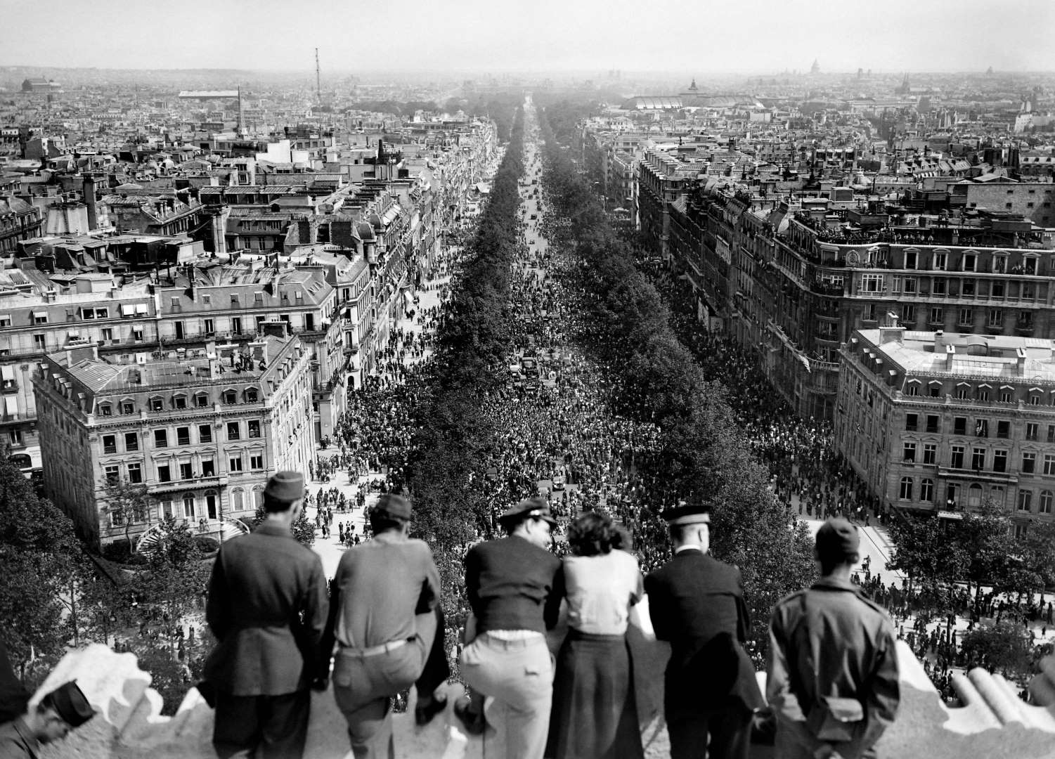 United States Army personnel on top of l’Arc de Triomphe in Paris, France watching the celebration in the streets over the war in Europe coming to an end, 8 May 1945.
