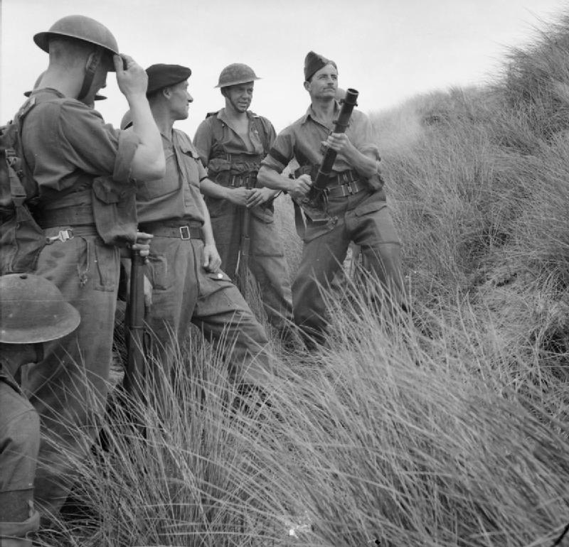Instructor showing men of UK Royal Welch Fusiliers how to fire a 2-inch mortar from the hip, Northern Ireland, United Kingdom, 21 Aug 1942