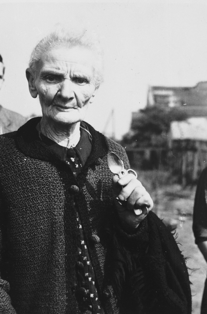 Mrs. Jaworska holding a few possessions she recovered out of her bombed out home, Warsaw, Poland, Sep 1939