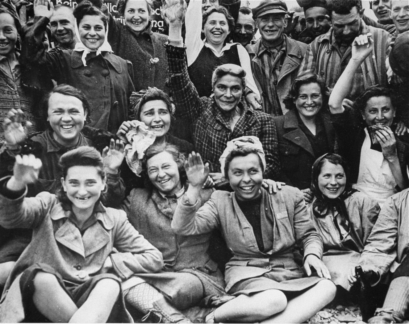 Prisoners celebrating, Dachau Concentration Camp, Germany, 29 Apr 1945; note female prisoners in foreground
