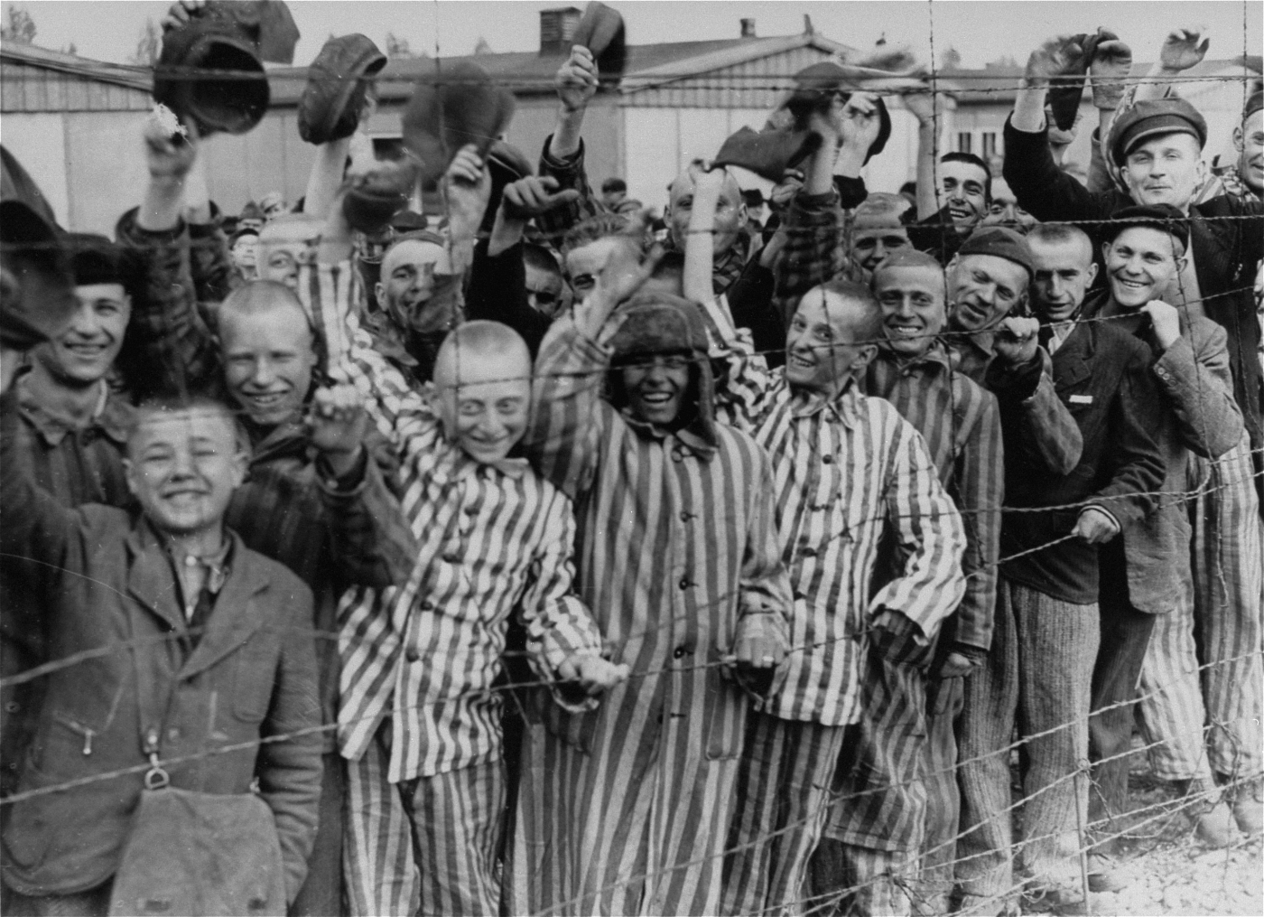 Prisoners celebrating the arrival of United States Army troops, Dachau Concentration Camp, Germany, 29 Apr 1945