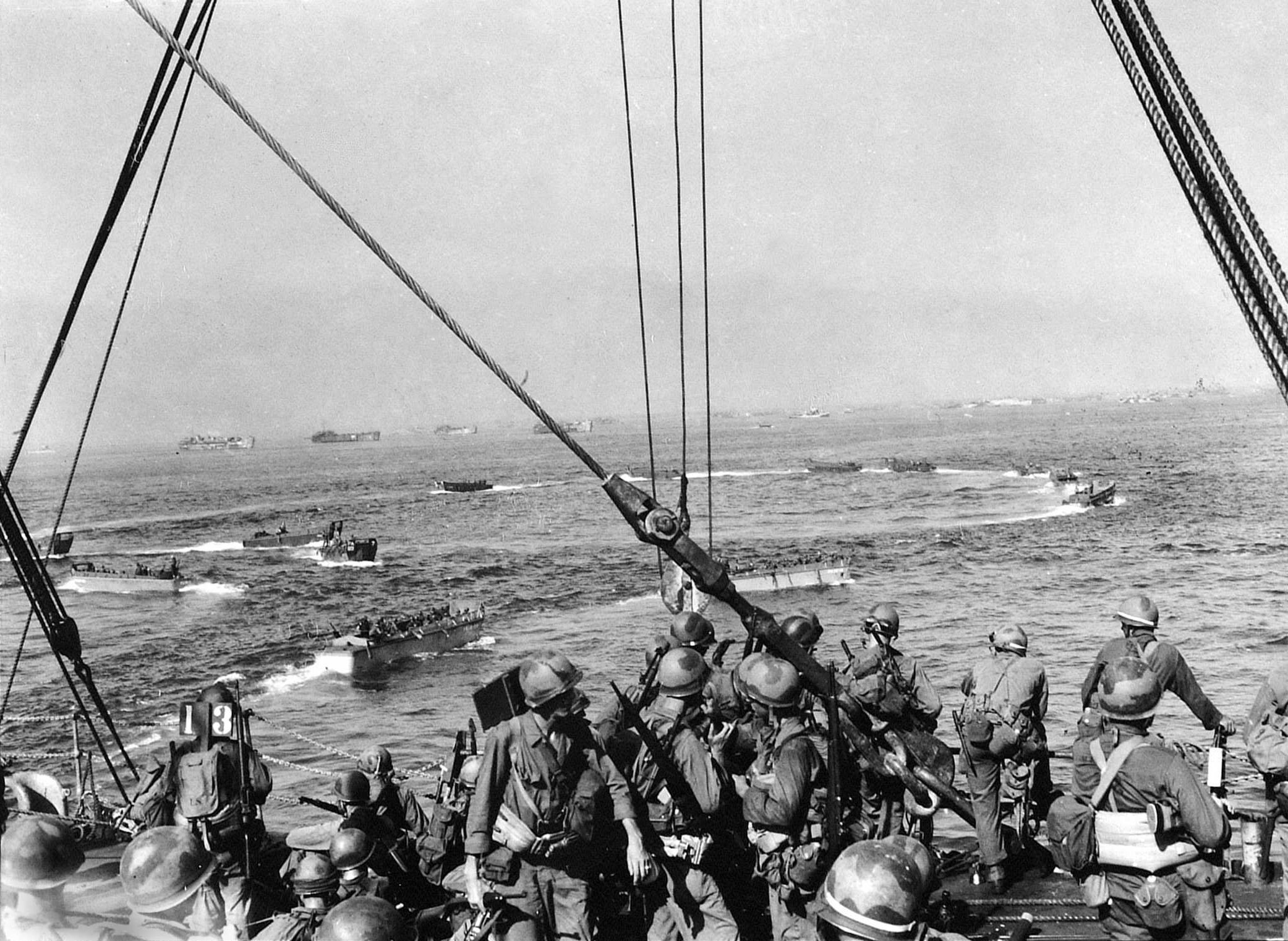 United States Army troops of the 19th Infantry Regiment, 3rd Battalion disembarking the USS Elmore bound for the landing beaches at Leyte, Philippines, 20 Oct 1944.
