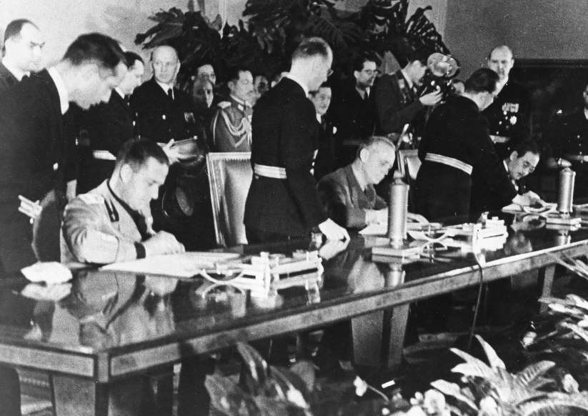 The signing of the Tripartite Pact at the Reich Chancellery in Berlin, Germany, 27 Sep 1940.  The signers are, left to right, Galeazzo Ciano of Italy, Joachim von Ribbentrop of Germany, and Saburo Kurusu of Japan.