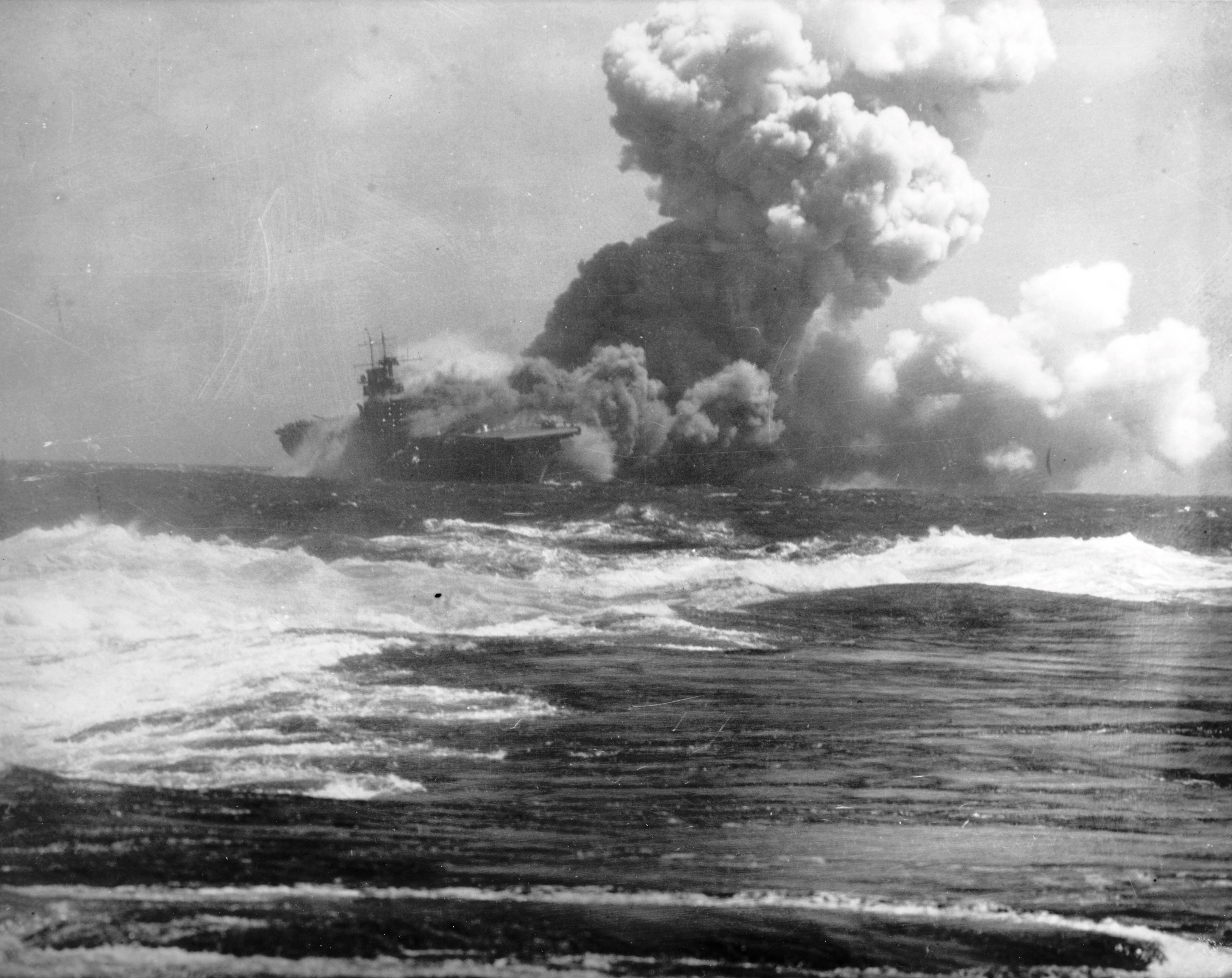 Wasp (Wasp-class) burning and listing after being torpedoed by Japanese submarine I-19 in the South Pacific, 15 Sep 1942. Photo 2 of 2.