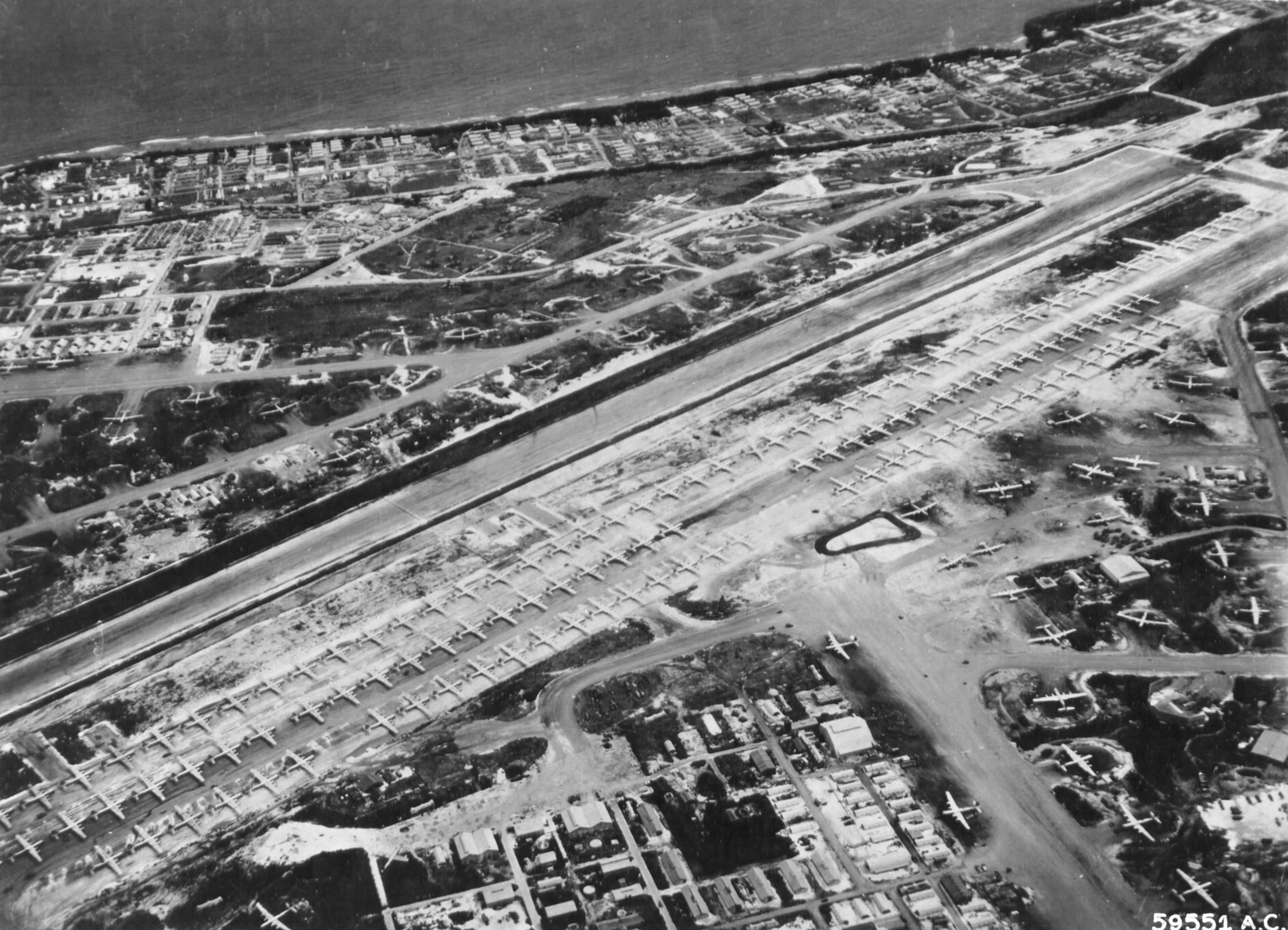 119 B-29 Superfortress bombers of the 73rd Bomb Wing lined up on Baker runway, Isley Field, Saipan, Mariana Islands, Sep 1945 with 35 more B-29s seen in the periphery.