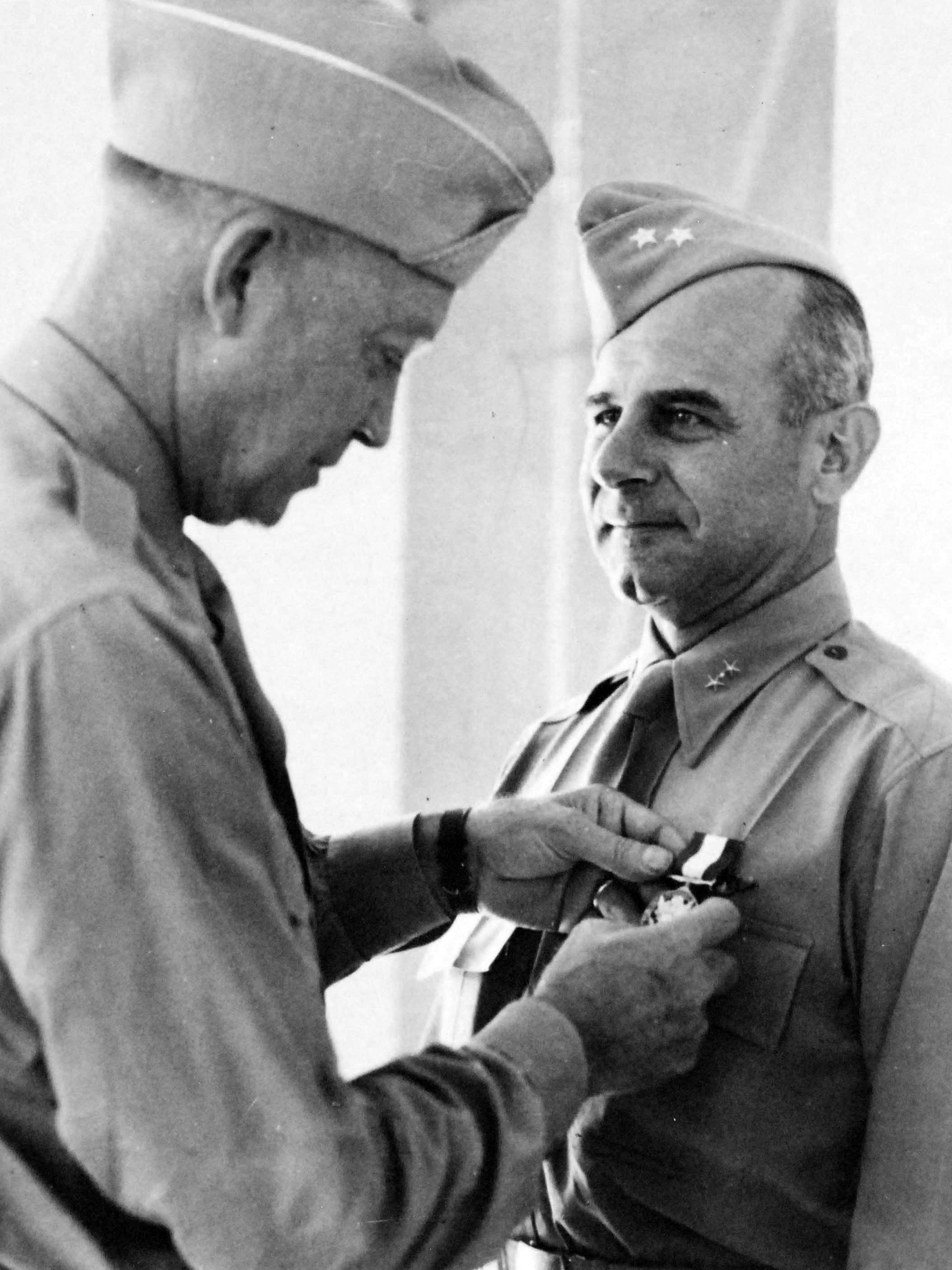General Dwight Eisenhower presenting the Distinguished Service Medal to Major General James Doolittle at a ceremony in North Africa, probably Tunisia, late 1943.