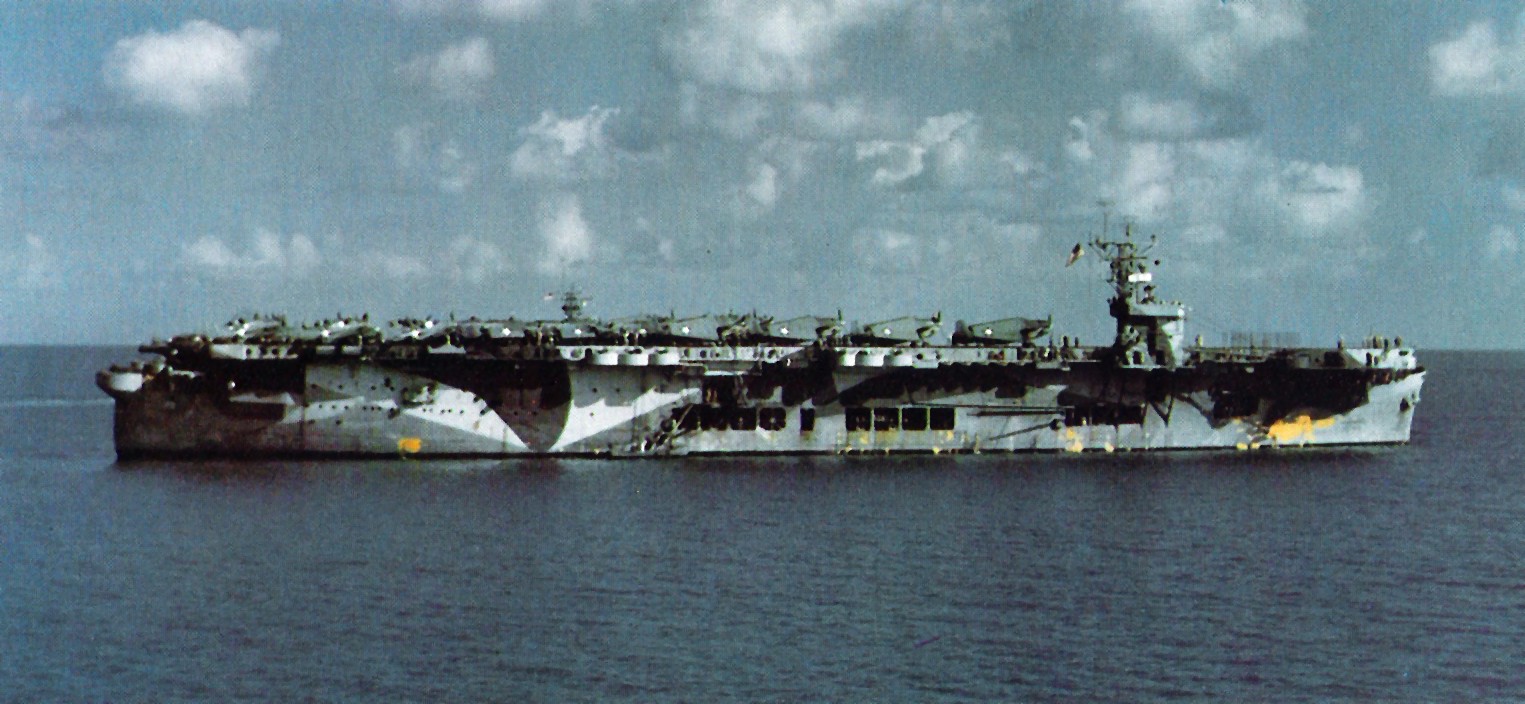 Escort carrier USS Santee in Oct 1942, probably in Bermuda, preparing to cross the Atlantic for the Operation Torch landings in North Africa. Note SBD Dauntless, F4F Wildcat, and TBF Avenger aircraft on the flight deck.