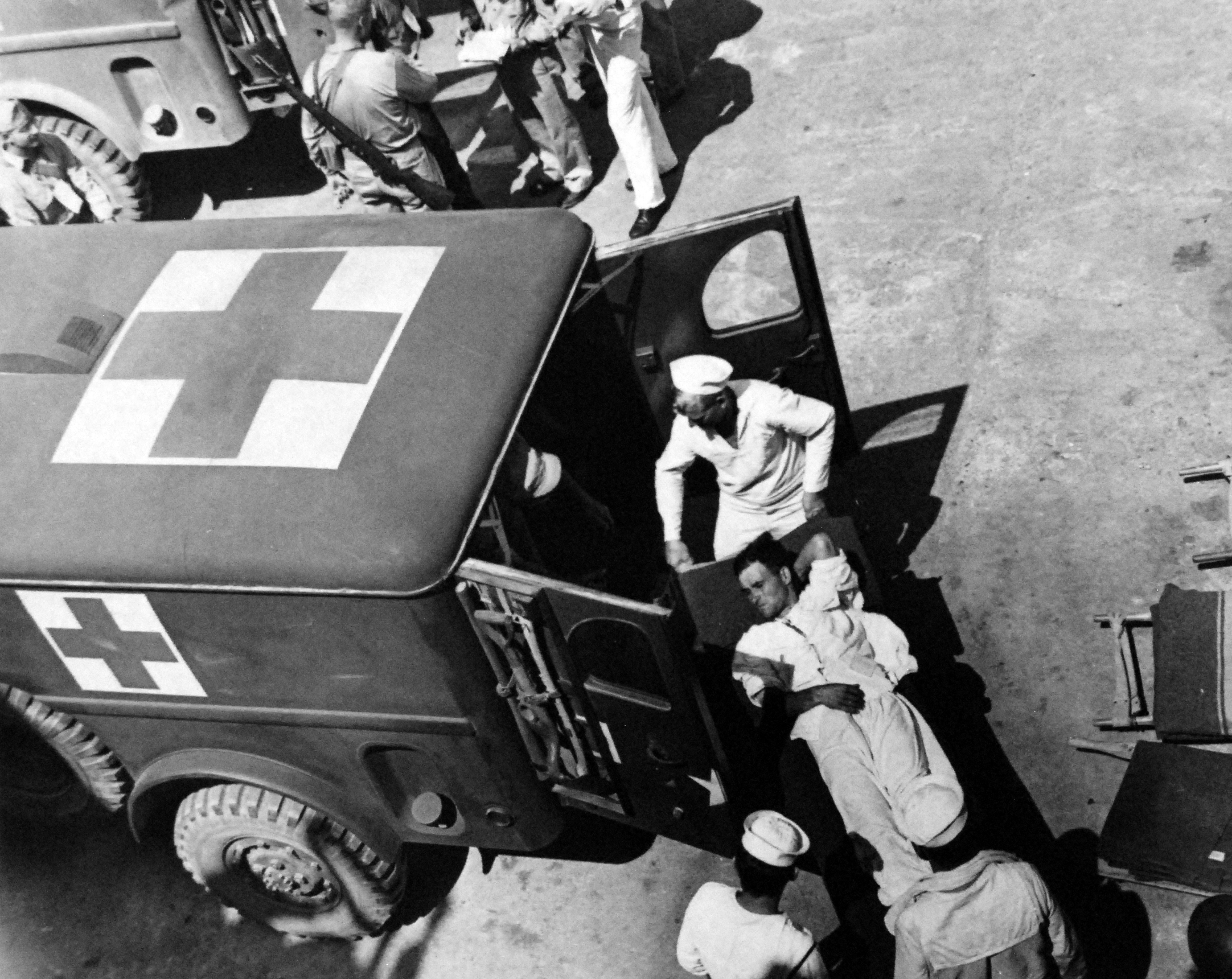 Wounded Italian soldiers from the Sicily invasion being transferred from a ship to waiting WC54 ambulances at Mers-el-Kebir, Algeria, July 1943