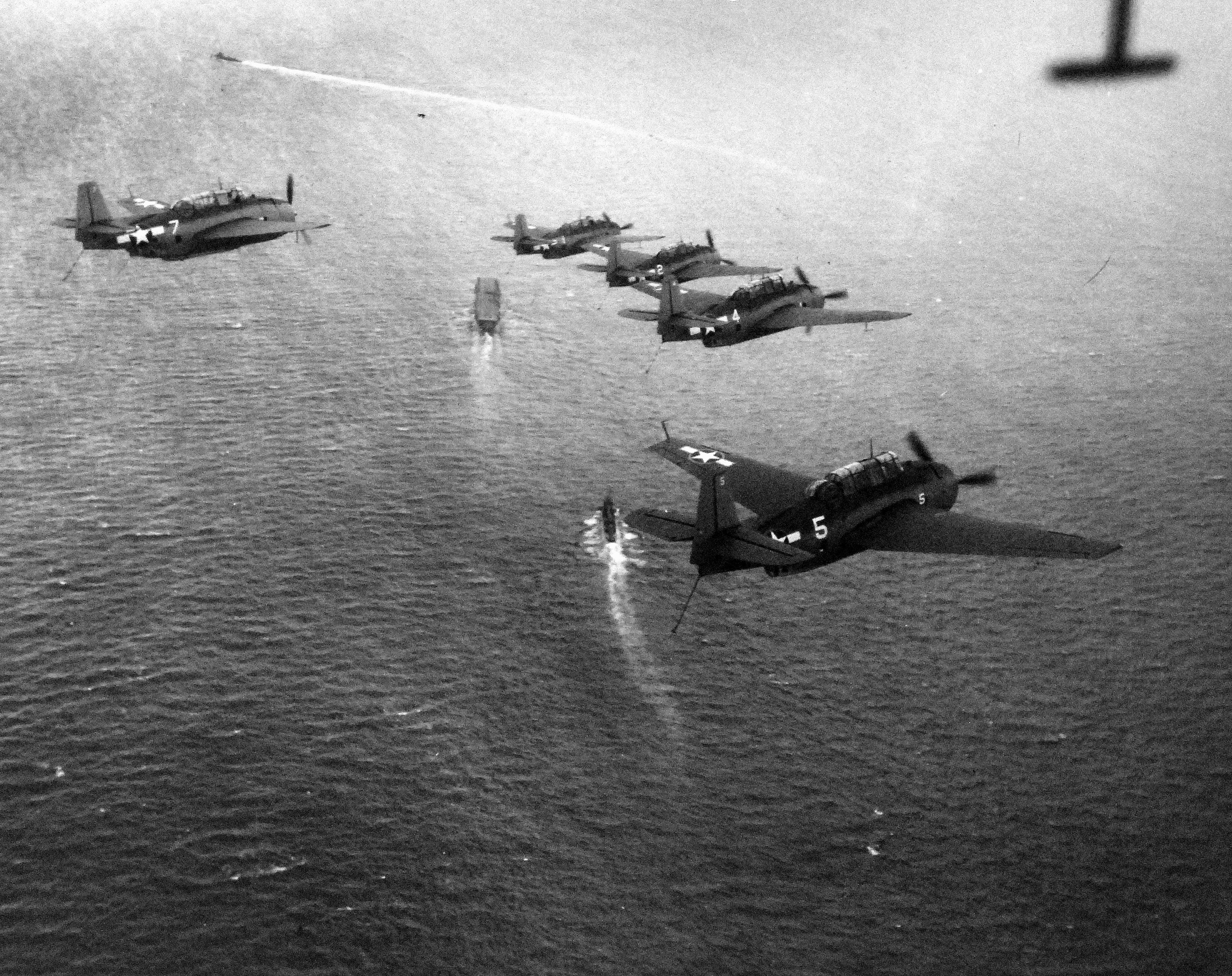 TBF Avengers in formation over the carrier USS Ranger with destroyer USS Forrest trailing while training in the Atlantic off Scapa Flow, Scotland, United Kingdom, 4 Sep 1943.