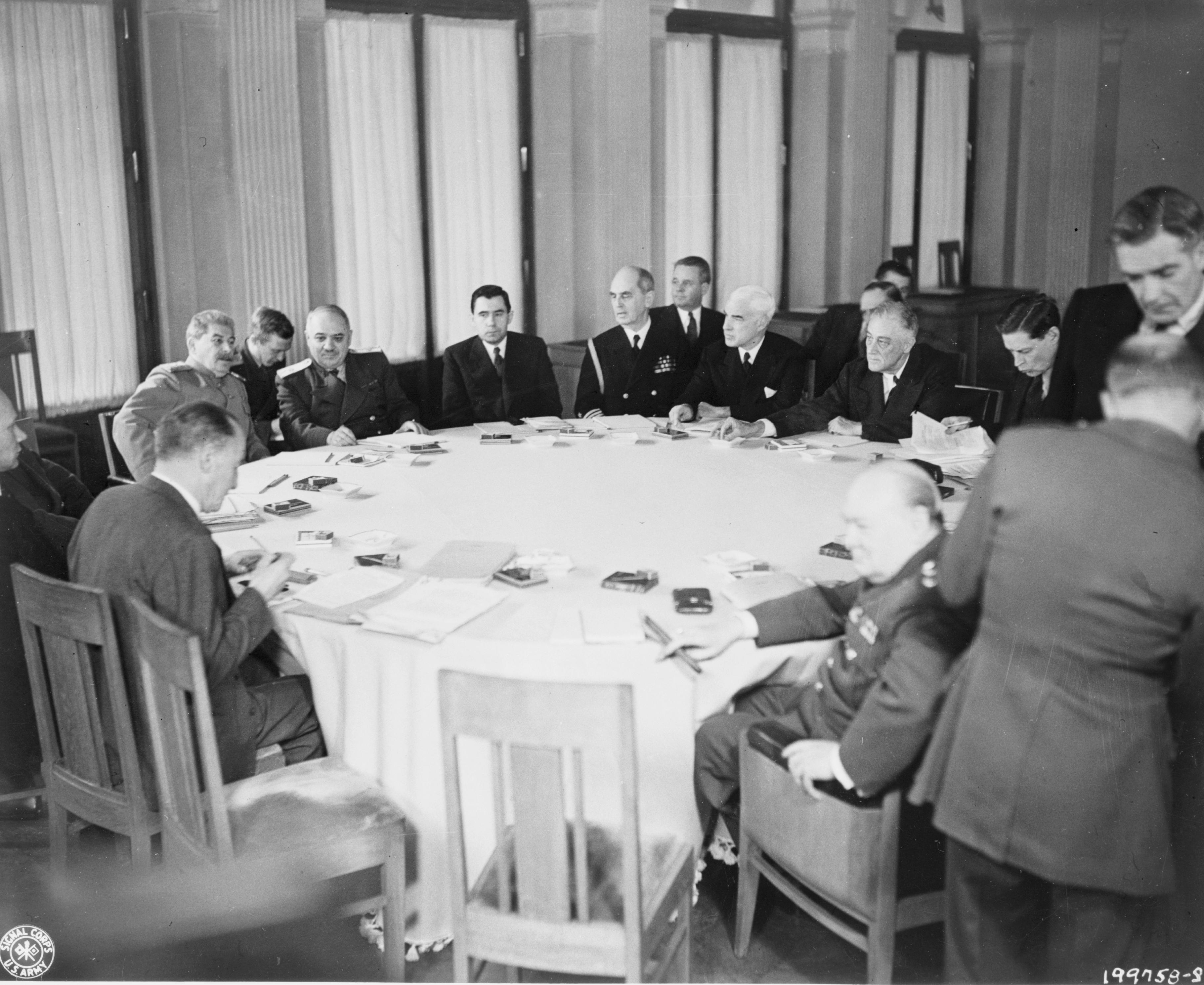 The conference table for the Yalta Conference, Feb 1945. Note Stalin, Roosevelt, and Churchill along with other officials seated around the table.
