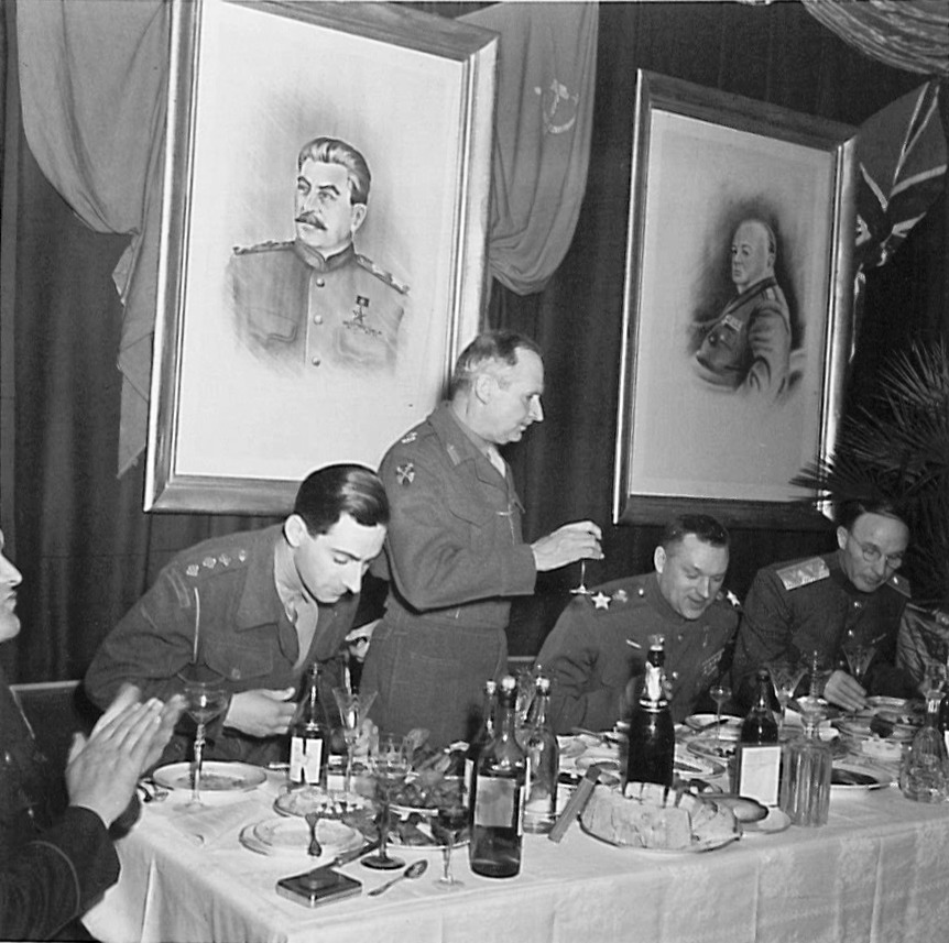 British Field Marshal Bernard Montgomery stands to propose a toast during a dinner at the headquarters of Soviet General Konstantin Rokossovsky in Wismar, Germany, 7 May 1945.