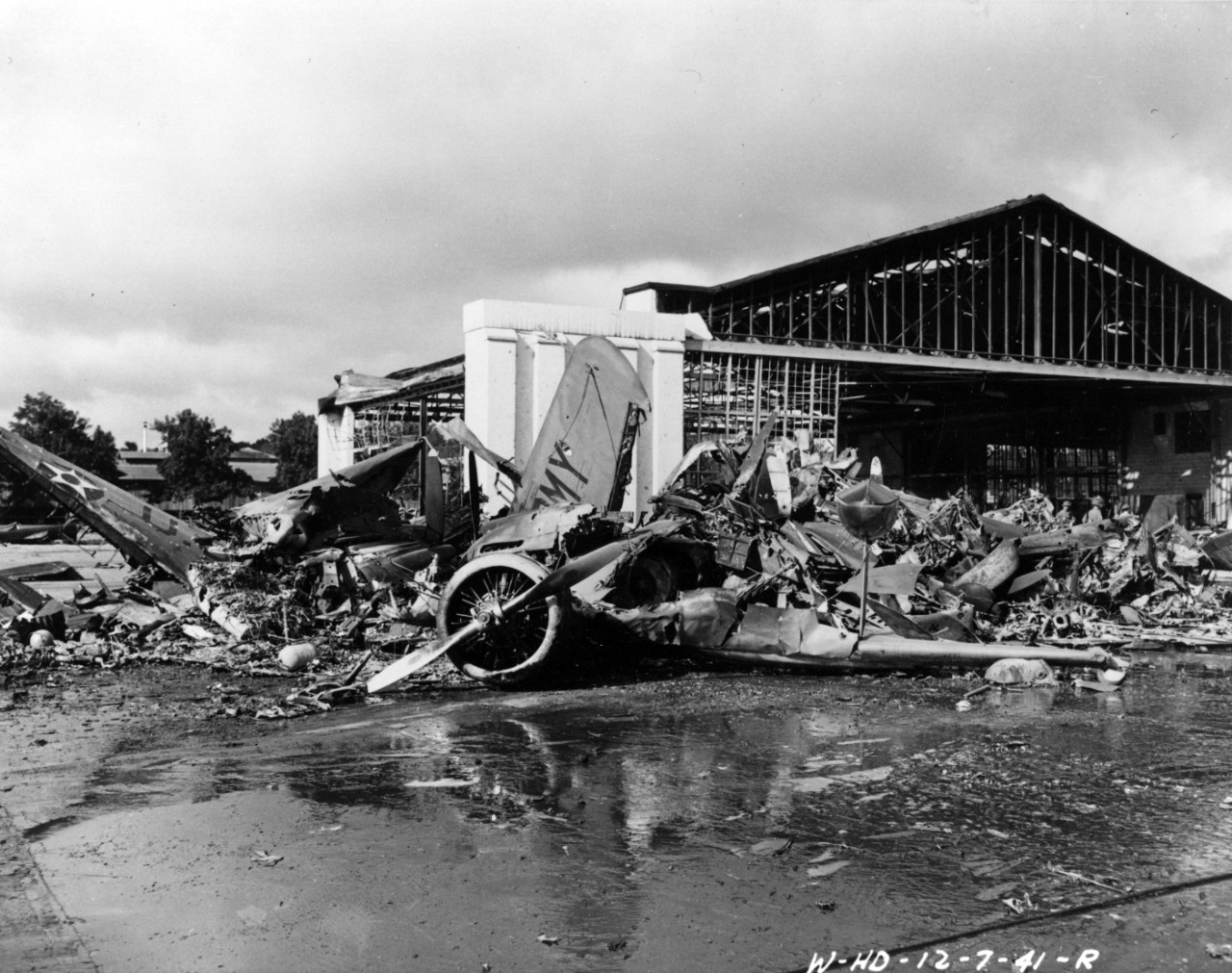 Aircraft wreckage on the ramp at Wheeler Field, Oahu, Hawaii, following the air attack of 7 Dec 1941.