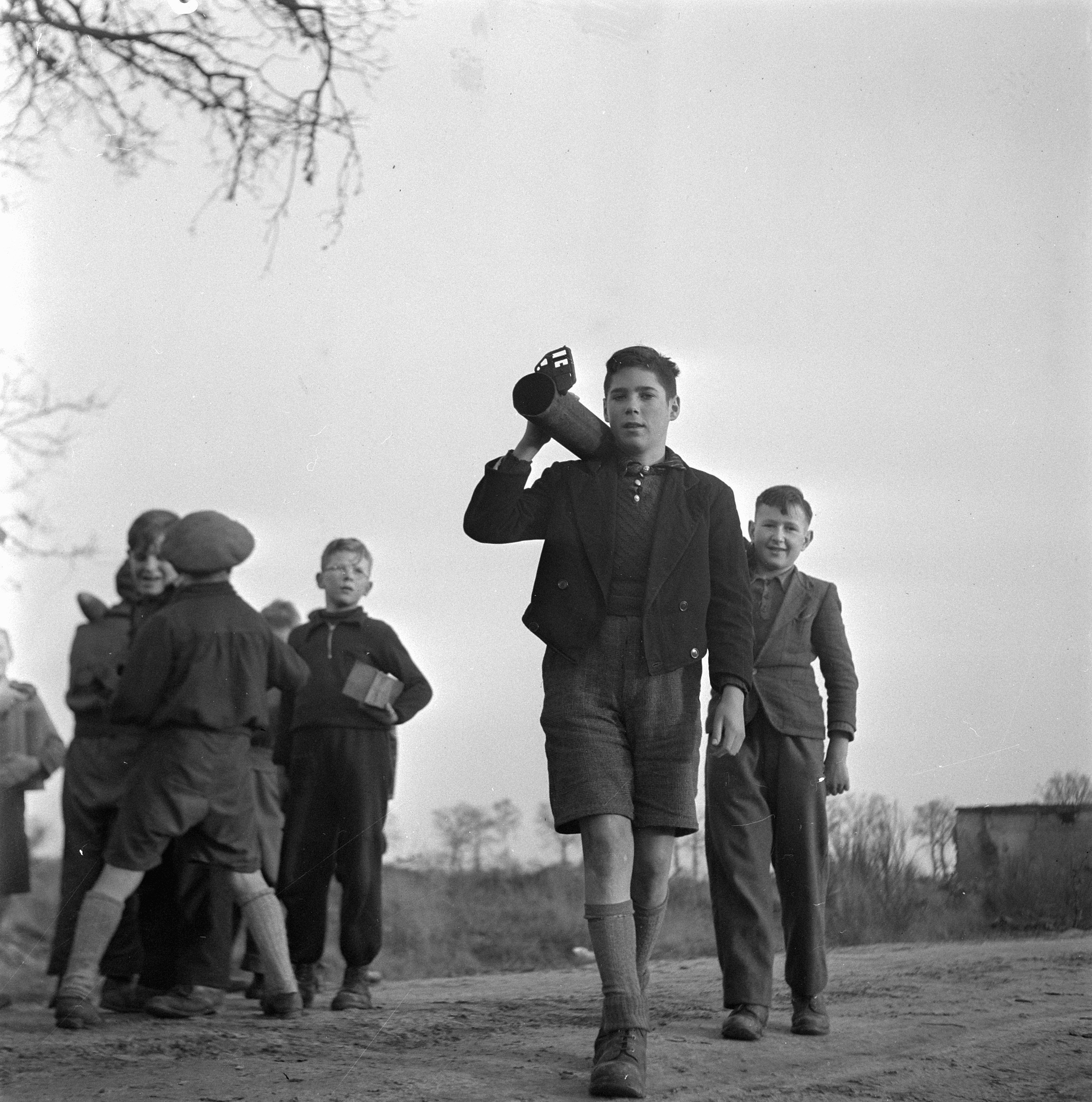 Children playing with a Panzerschreck launcher left behind by German troops, southern Netherlands, 24 Dec 1945