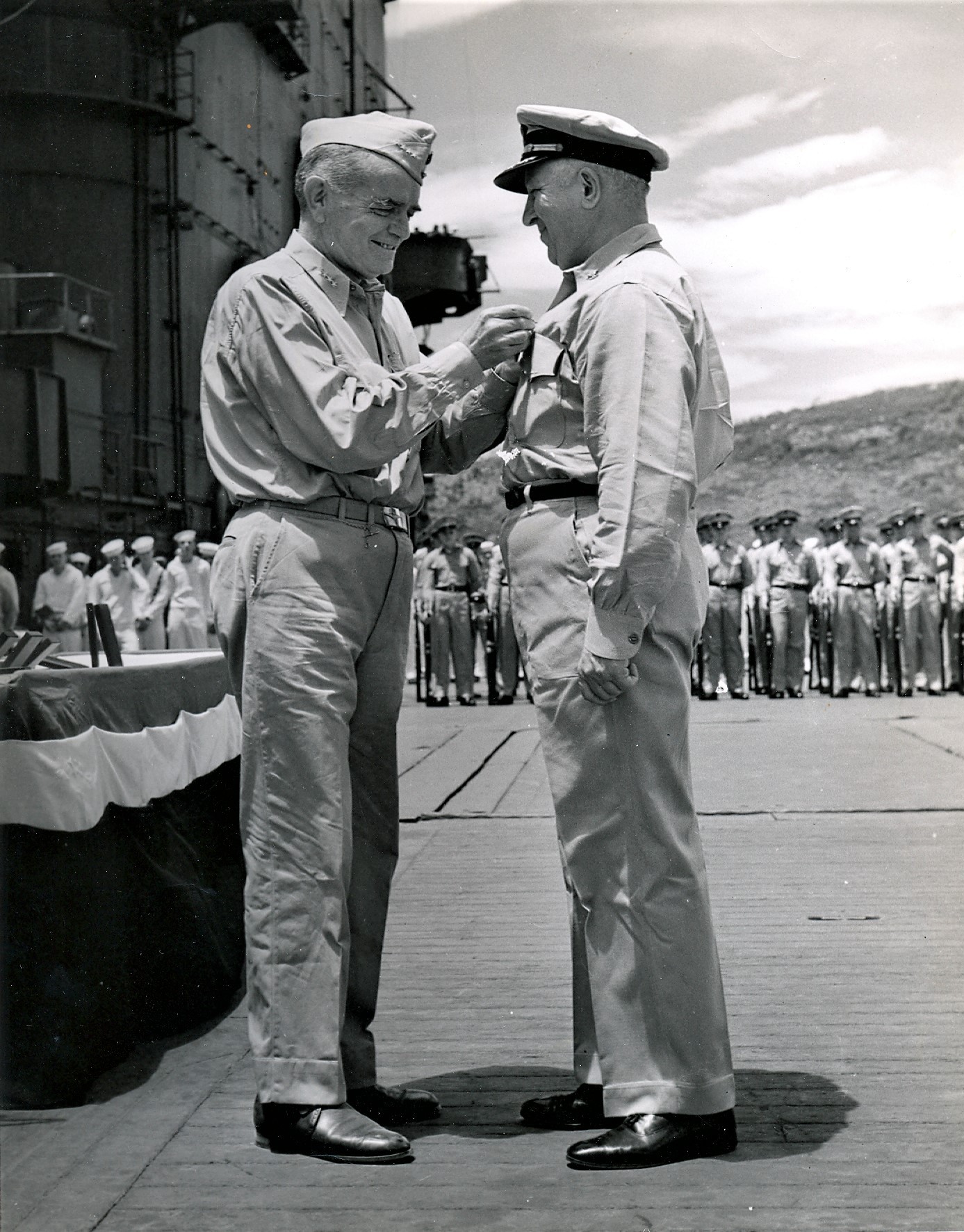 Admiral William Halsey presenting an award to a United States Navy Captain on the flight deck of USS Saratoga in the South Pacific, circa 1942.