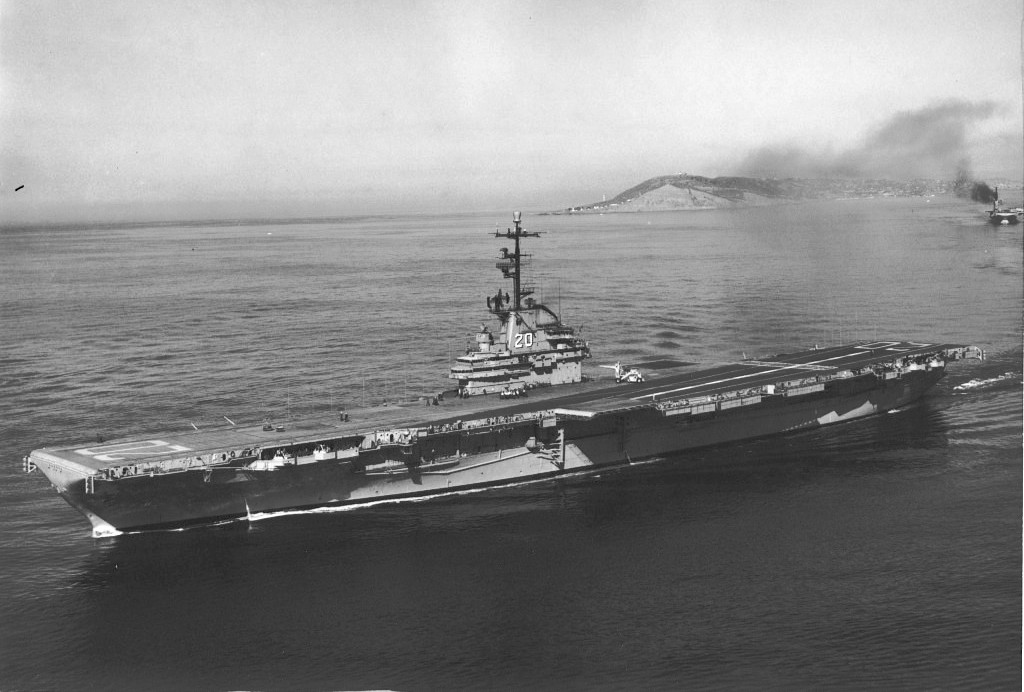 USS Bennington in her final configuration leaving San Diego, California in the late 1950s. Note the enclosed hurricane bow, the absence of most anti-aircraft guns, and the angled flight deck.