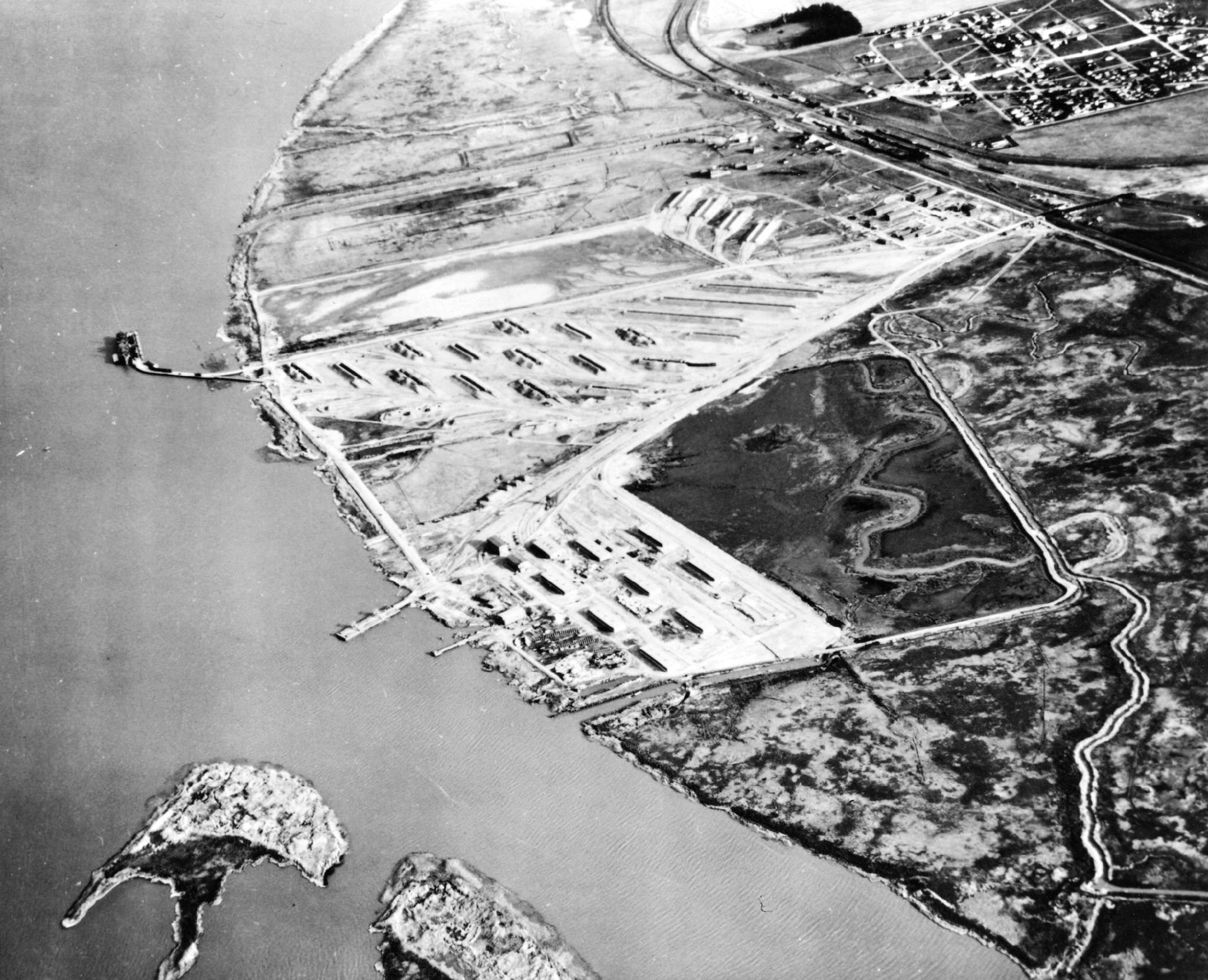Aerial View of the ammunition loading facilities at Port Chicago, California, United States, Apr 1944. The curved pier at left is where the 17 Jul 1944 explosion took place.