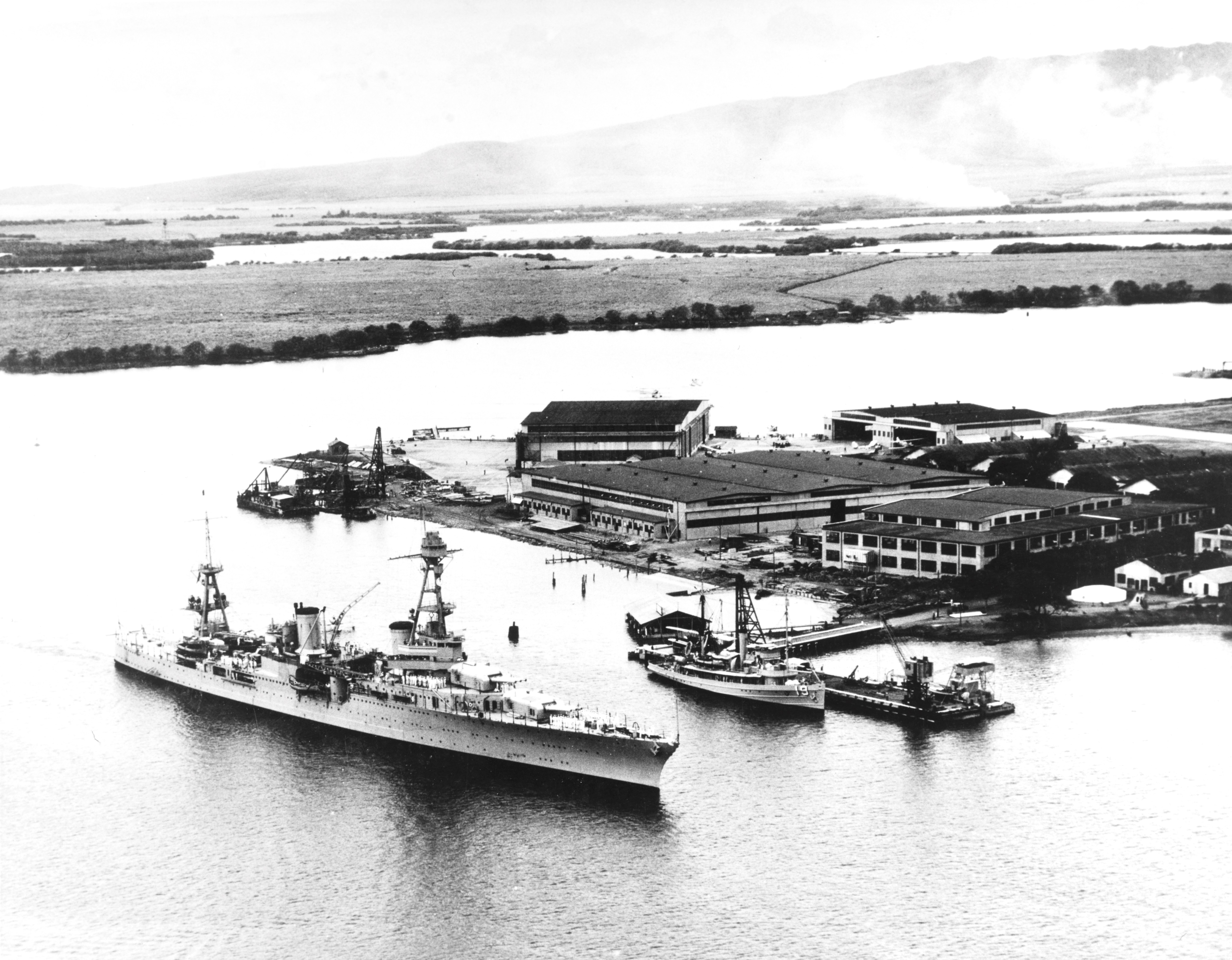 Cruiser USS Augusta entering Pearl Harbor, Hawaii passing the Ford Island seaplane hangars and minesweeper Avocet, 1933.