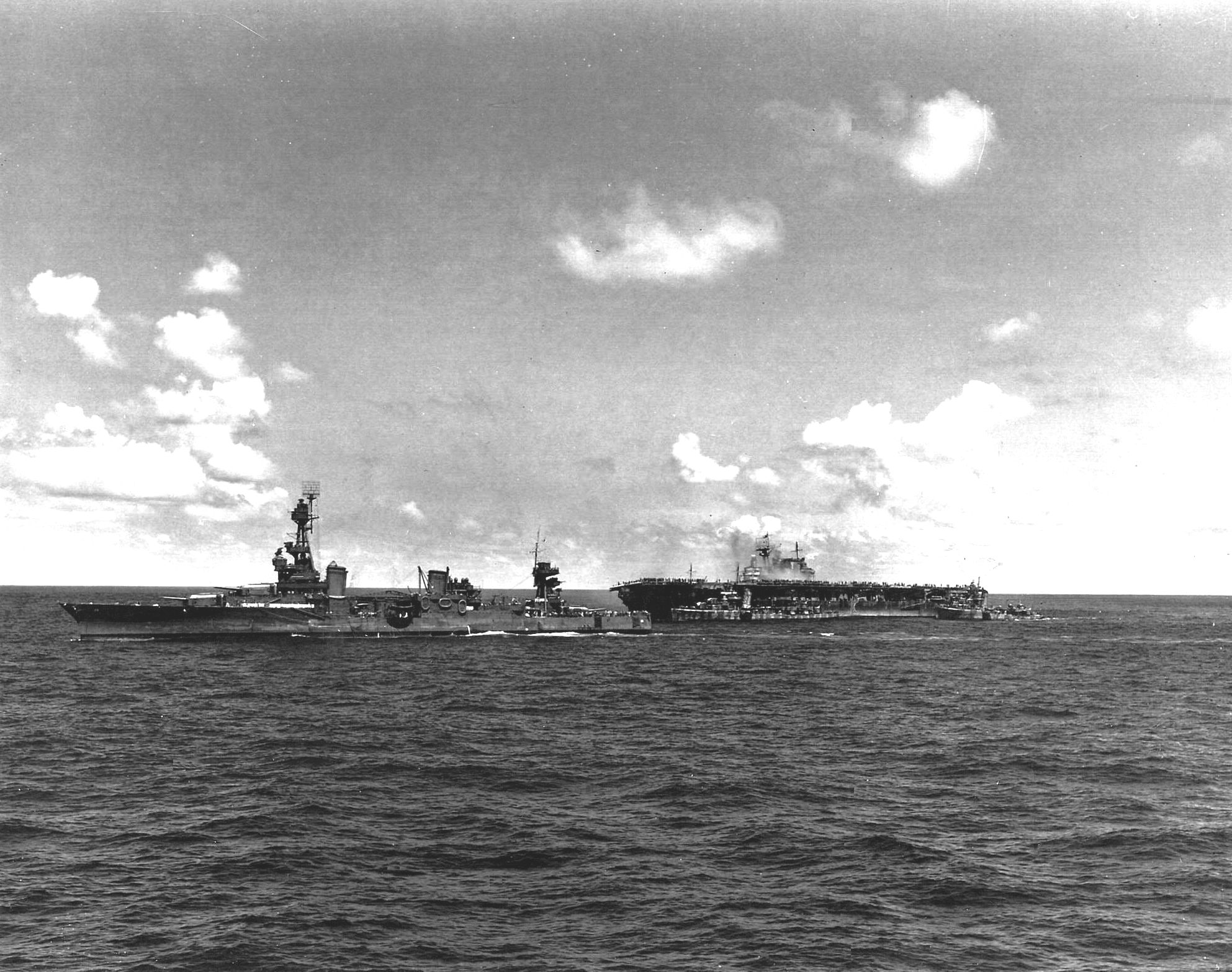 Cruiser USS Northampton making preparations to take the stricken USS Hornet (Yorktown-class) under tow, Battle of Santa Cruz Islands, 26 Oct 1942. Note destroyer USS Russell alongside Hornet's port side. Photo 1 of 2.