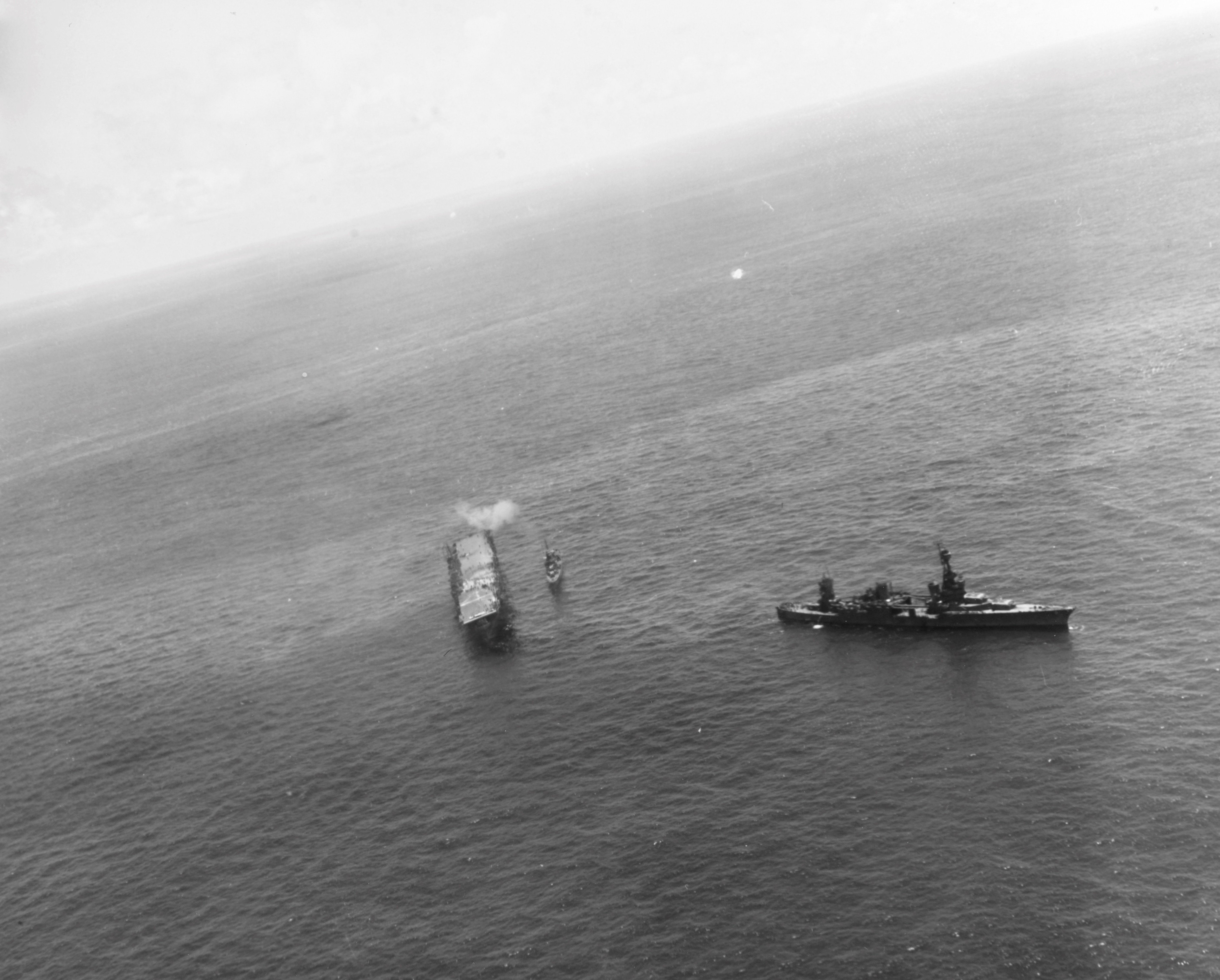 Cruiser USS Northampton making preparations to take the stricken USS Hornet (Yorktown-class) under tow, Battle of Santa Cruz Islands, 26 Oct 1942. Note destroyer USS Russell alongside Hornet's port side. Photo 1 of 2.