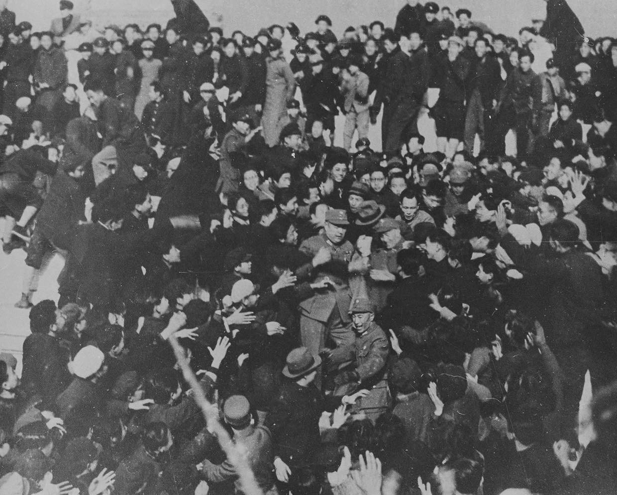 Students eager to shake hands with Chiang Kaishek after Chiang had given a speech, Hall of Supreme Harmony, Forbidden City, Beiping, China, 15 Dec 1945; note General Huang Renlin and bodyguard Qian Shushi