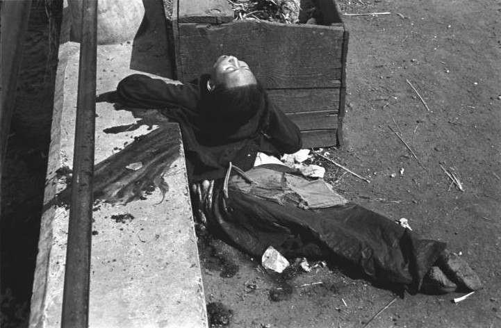 Chinese woman killed by Japanese bombing at the side of a bridge, Shanghai, China, mid-1937, photo 2 of 3