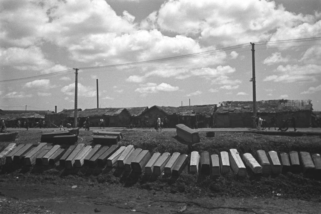 Coffins on the side of a road, Shanghai, China, mid-1937