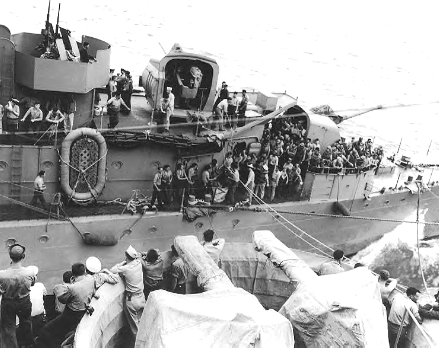 Destroyer USS Shaw transferring survivors of sunken destroyer USS Porter to battleship USS South Dakota (foreground) while underway toward Efate, New Hebrides, 28 Oct 1942.