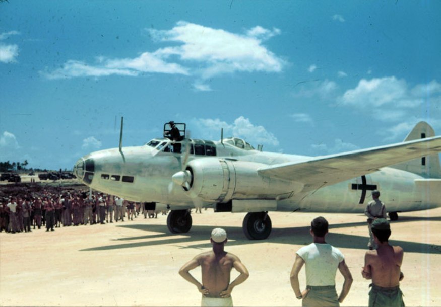 Aboard two Mitsubishi G4M ‘Betty’ bombers in surrender markings, a Japanese delegation stopped at Ie Jima, Ryukyu Islands en route Manila, Philippines for a surrender briefing, 19 Aug 1945. Photo 05 of 12.