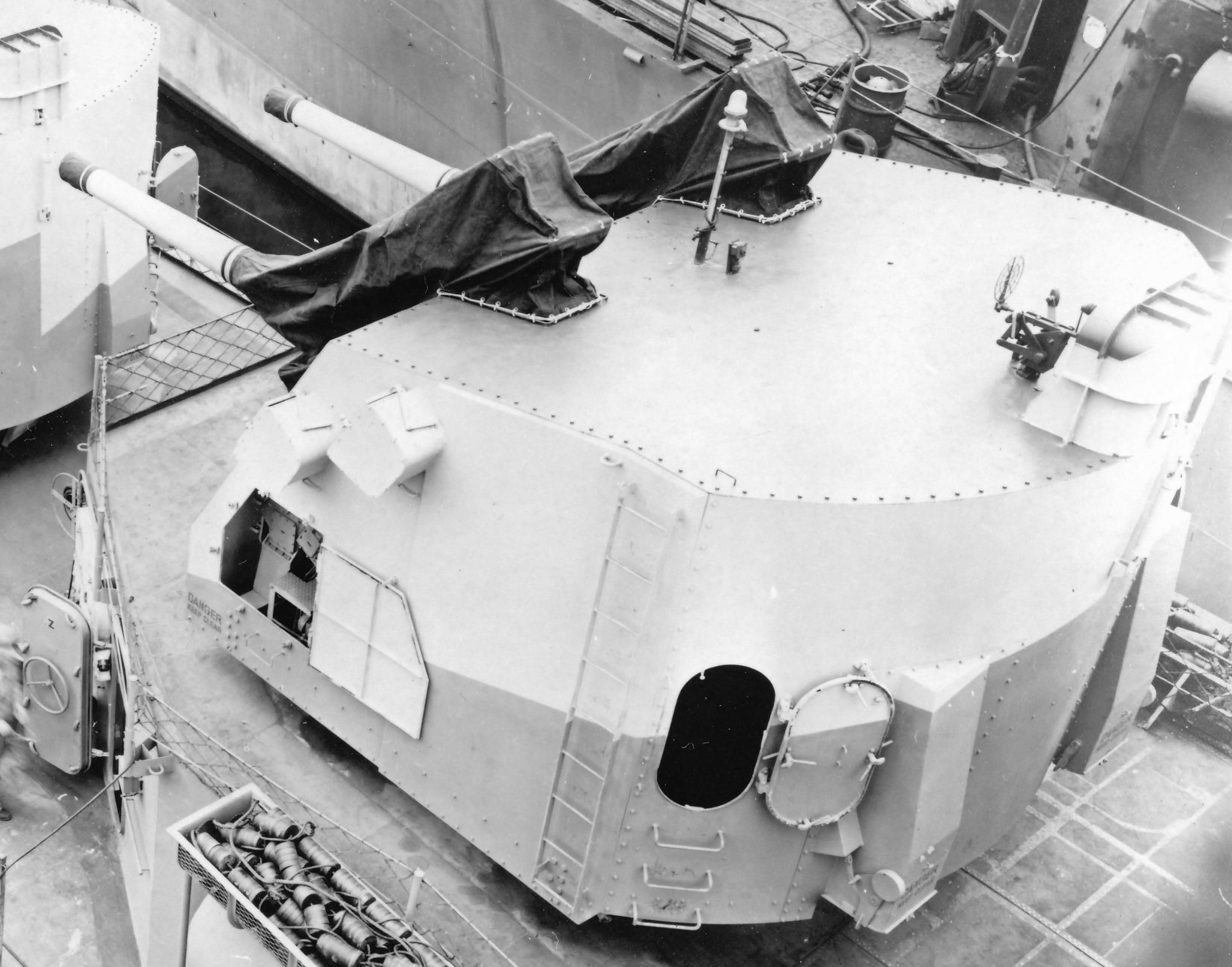 Twin mounted 5-inch/38 caliber gun turret aboard an Allen M. Sumner-class destroyer. Note expended casings in netting beside the turret.