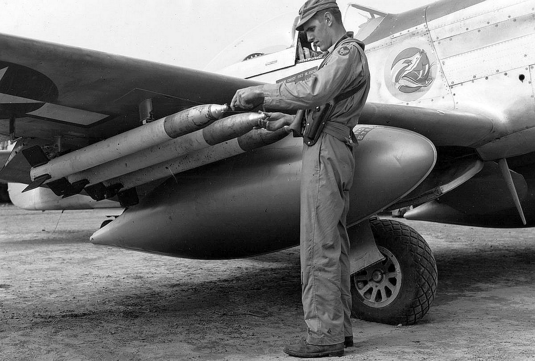 Commander of USAAF 78th Fighter Squadron Major James B. Tapp checking the fuses on his HVAR air-to-surface rockets mounted to his P-51D VLR Mustang ‘Margaret-V’ 44-73407 at South Field, Iwo Jima, spring 1945.