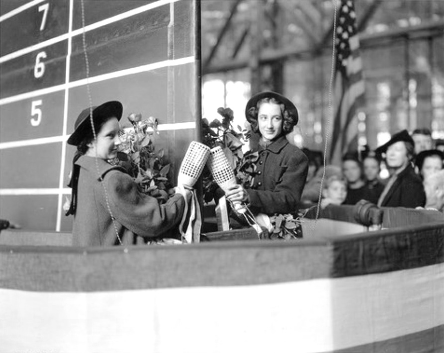 Ann and Mildred Stahlman, the daughters of the president of 'The Nashville Banner,' a prominent Nashville newspaper, prepare to christen the cruiser Nashville 2 Oct 1937 at Camden, New Jersey, United States.