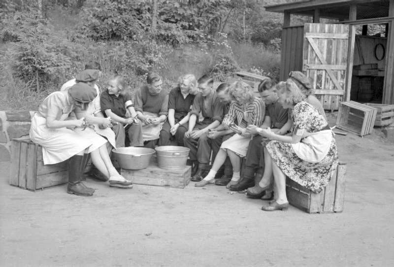 RAF personnel and Norwegian civilians peeling potatoes at an RAF station of 88 Group, Oslo, Norway, 1945
