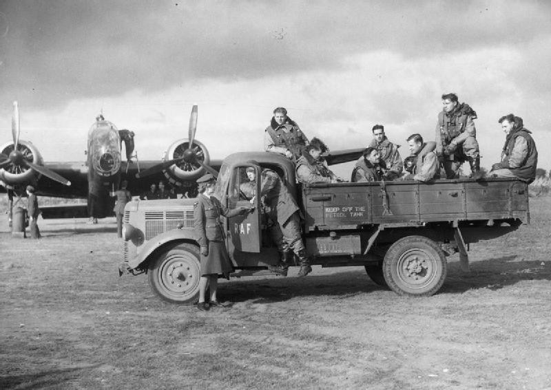 Handley Page Hampden crewmembers of No. 83 Squadron RAF Bomber Command arriving at their aircraft in a lorry driven by a WAAF member, RAF Scampton, Lincolnshire, England, United Kingdom, 2 Oct 1940