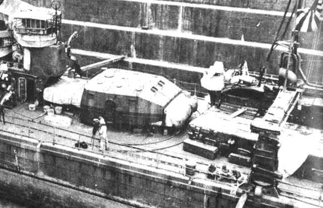 Typical torpedo tube mounts for Japanese destroyers. Note that the tubes are encased in a turret to offer them some protection from gunfire or bomb fragments. Note also replacement torpedoes ready to be loaded (right).
