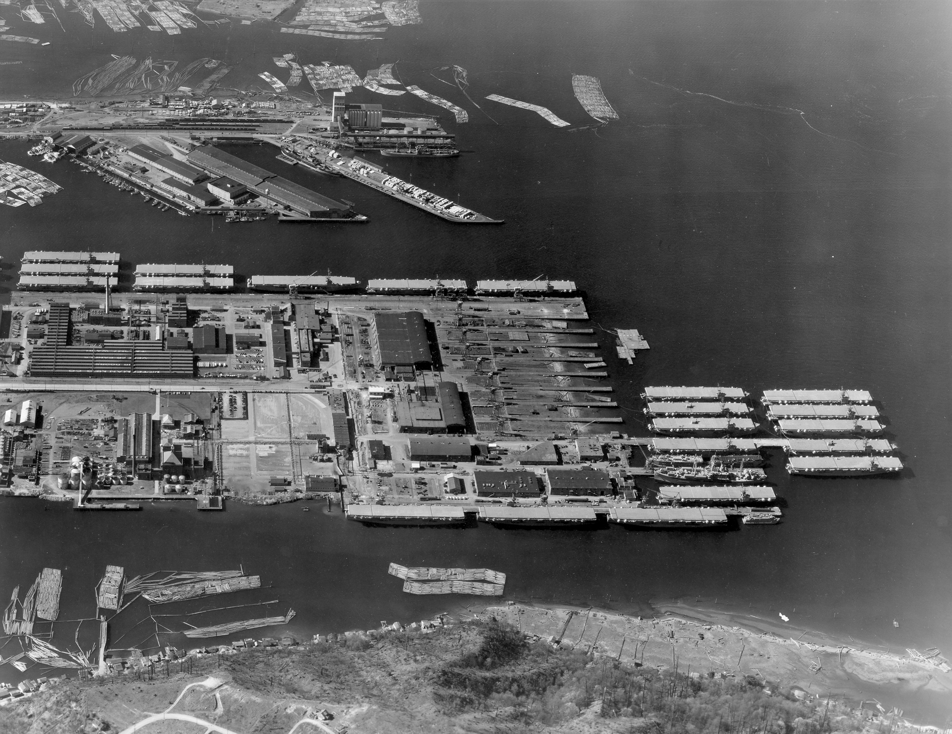 Todd-Pacific Shipyard, Tacoma, Washington, United States in 1942-43. 21 of the 37 Bogue-class escort carriers built at Todd-Pacific are seen in this photo and 5 more are just out of frame to the left.