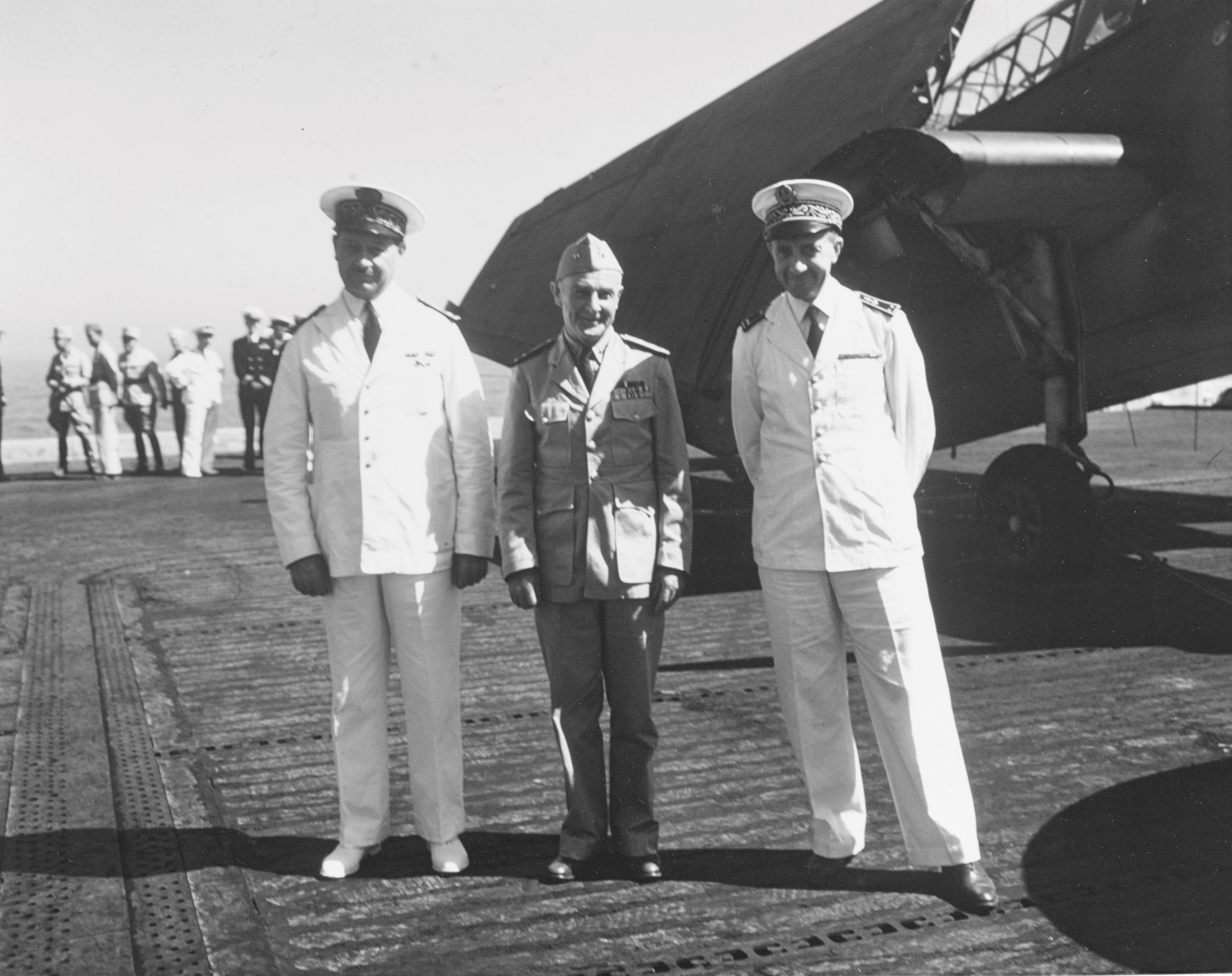 On the flight deck of USS Card in front of a TBF Avenger, US Navy Rear Admiral Frank Lowry (center) is flanked by two Rear Admirals of the French Navy, C.A. Ronarc’h (left) and Jacques Missoffe, Casablanca, 4 Jun 1943.