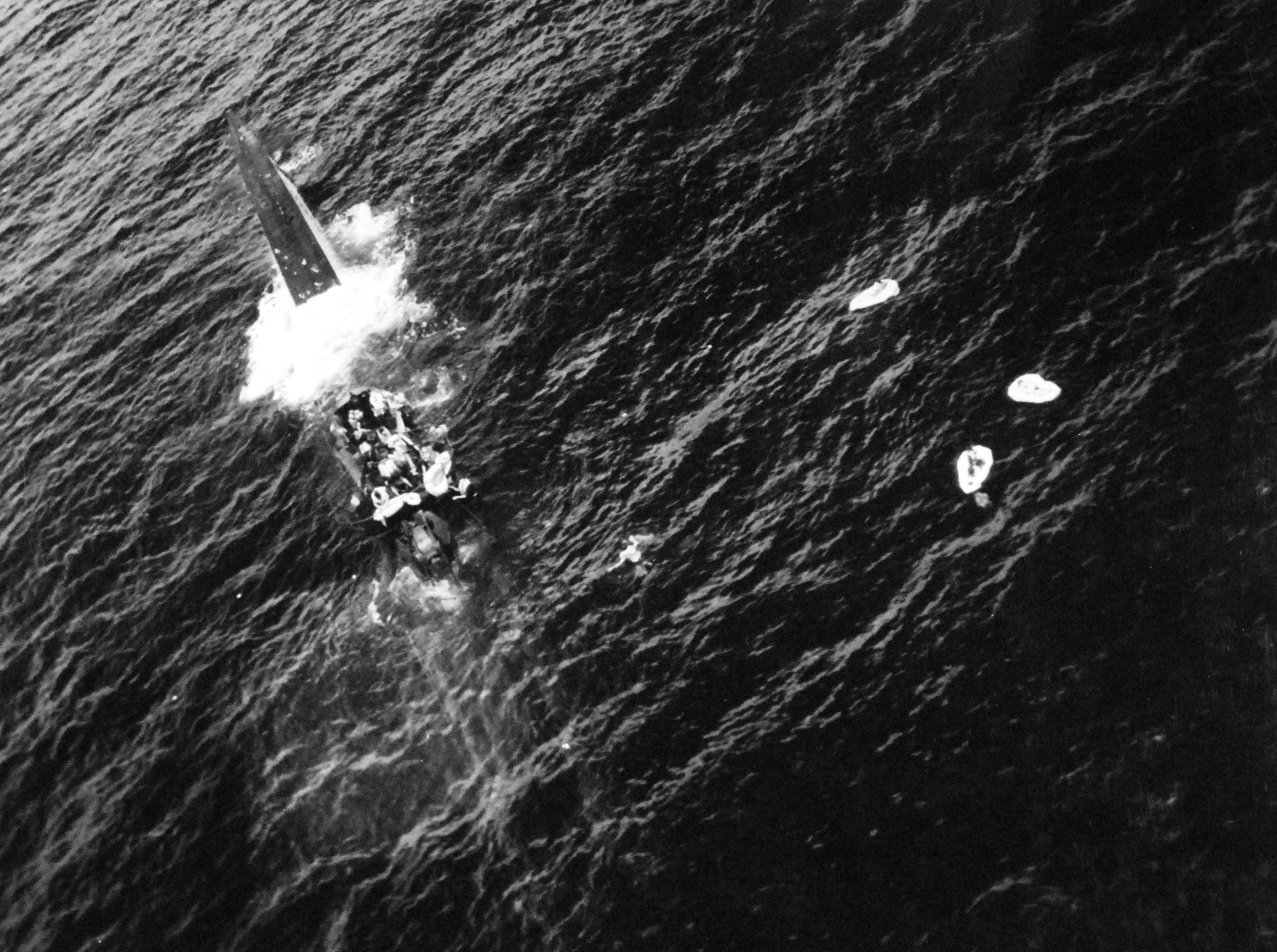 German submarine U-664 lying dead in the water and sinking by the stern as her crew abandoned ship following an air attack from USS Card aircraft in the mid-Atlantic, 9 Aug 1943. Photo 1 of 2.