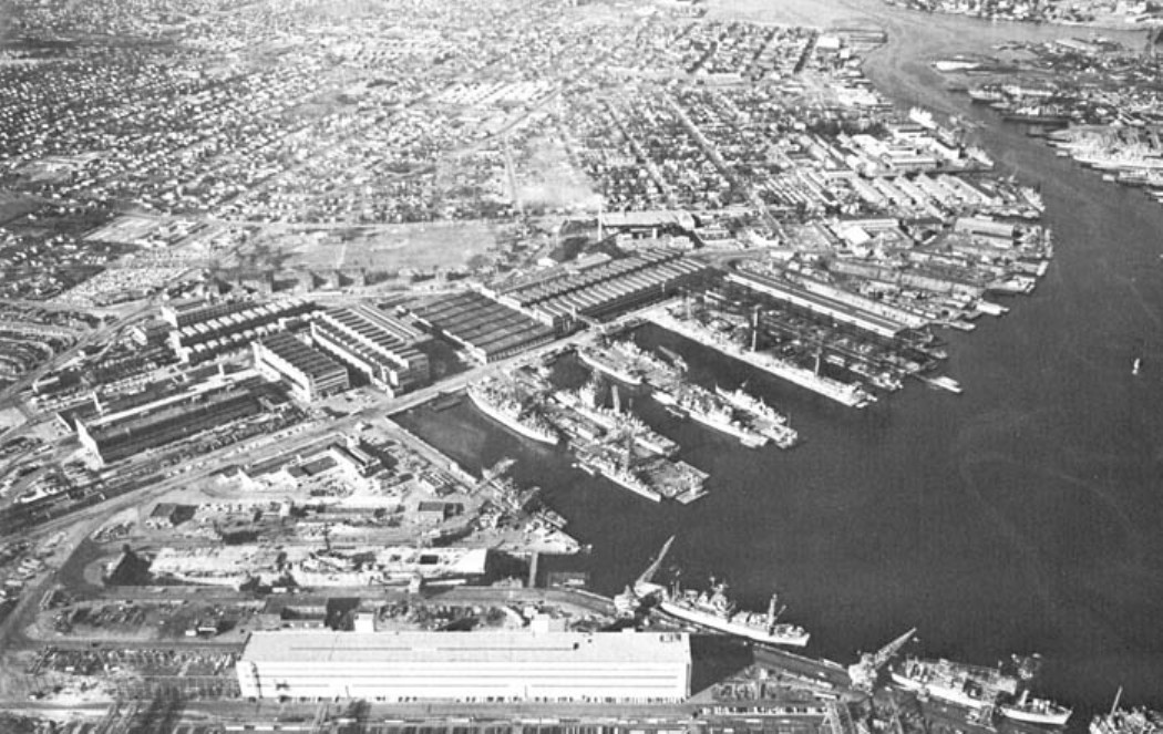 Aerial view looking north at the Norfolk Navy Yard, Portsmouth, Virginia, United States, about 1943. Note the short-hull Essex-class carrier in Drydock No. 8 (foreground).