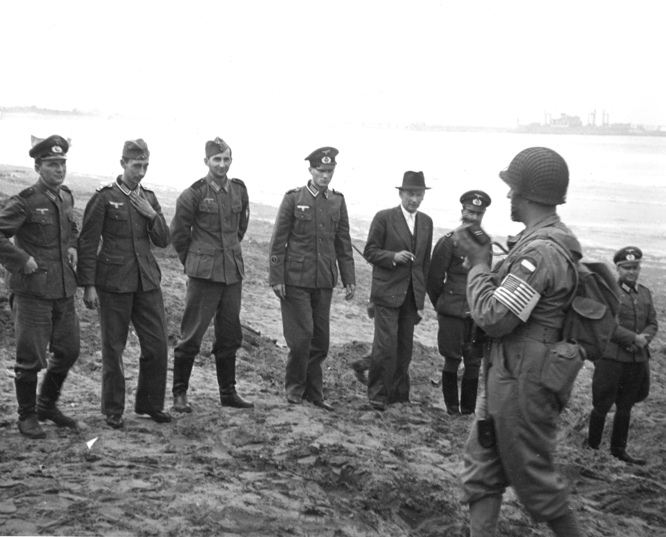 United States Army Lt Robert Longini photographing German prisoners of war captured during Operation Torch at Fedala, French Morocco (now Mohammedia, Morocco), Nov 1942.