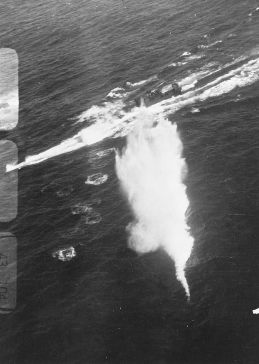 German submarine U-850 under attack by Lt Harold Bradshaw from Composite Squadron VC-19 flying from USS Bogue, 20 Dec 1943. Note what appears to be a Mark 24 FIDO homing torpedo entering the water.