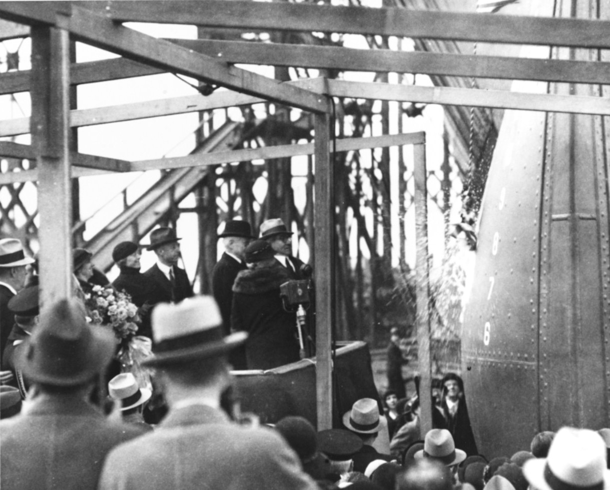 United States First Lady Mrs. Lou Hoover christening Ranger upon the ship’s launch at Newport News, Virginia, 25 Feb 1933. Behind Mrs. Hoover, in the dark hat, is Secretary of the Navy Charles Adams. Photo 2 of 2.