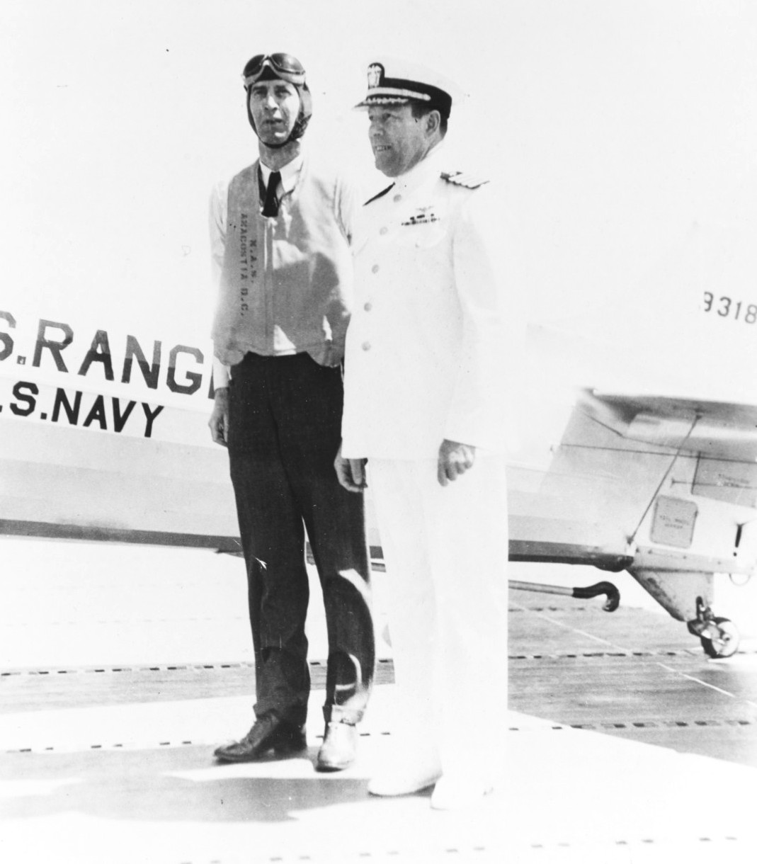Rear Admiral Ernest King on the flight deck of the USS Ranger speaking with the carrier’s captain, Arthur Bristol, 22 Jun 1934. Admiral King had just come aboard by aircraft.