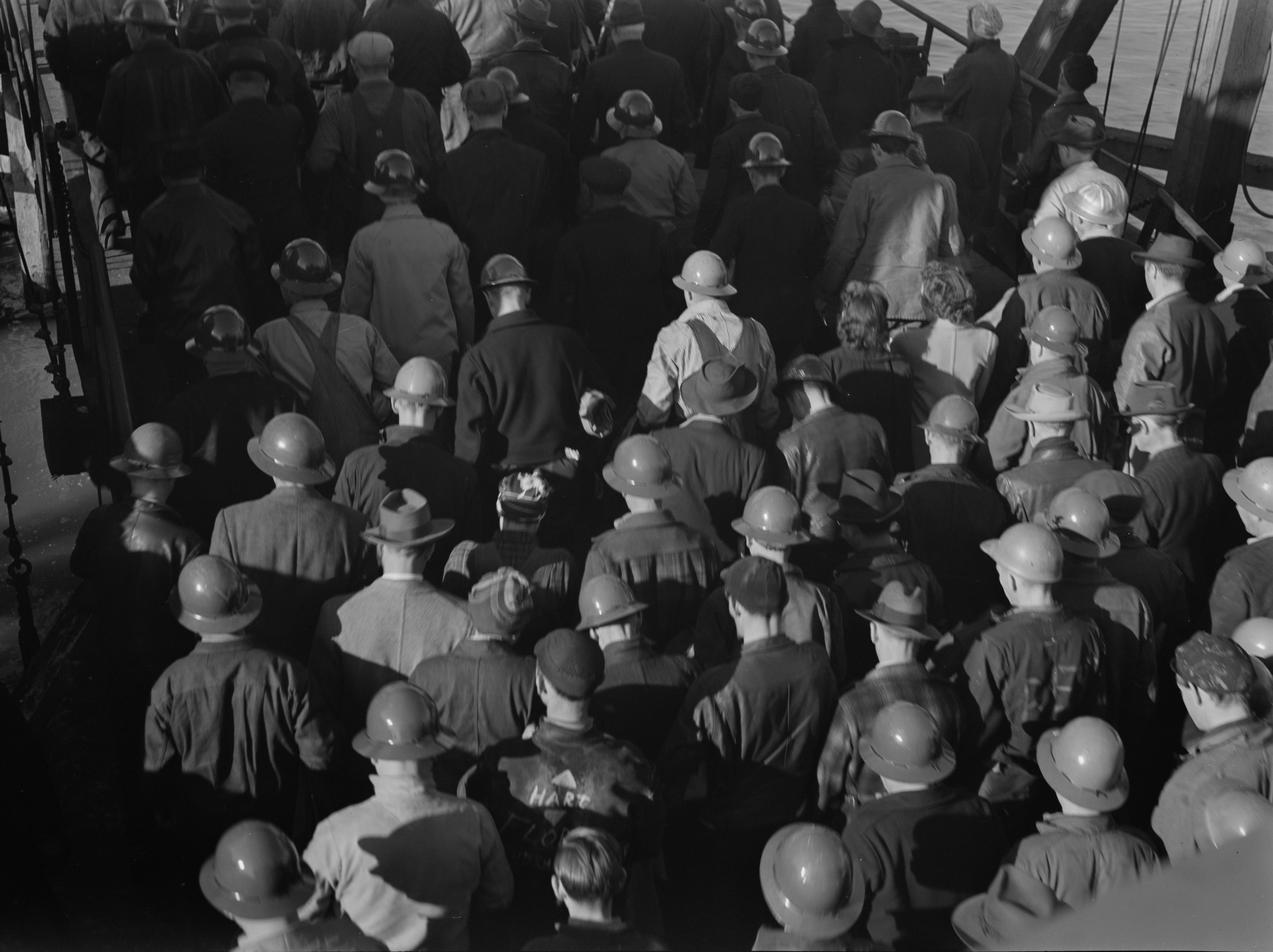 Shipyard workers arriving at the Kaiser Richmond Shipyards by ferry, Richmond, California, United States, Feb 1943