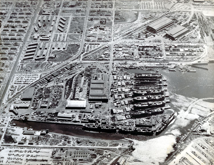 Aerial view of the seven original shipways of Kaiser Richmond Shipyard No. 1, early 1943. The large buildings in the upper right are the prefabrication sheds and Shipyard No. 2 is beyond them.