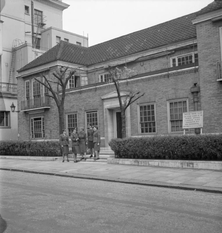 Acting Superintendent Mrs. Bolton of Women's Voluntary Service's Services Club at Chester House speaking to members of ATS and WAAF, Clarendon Place, Paddington, London, England, 1943