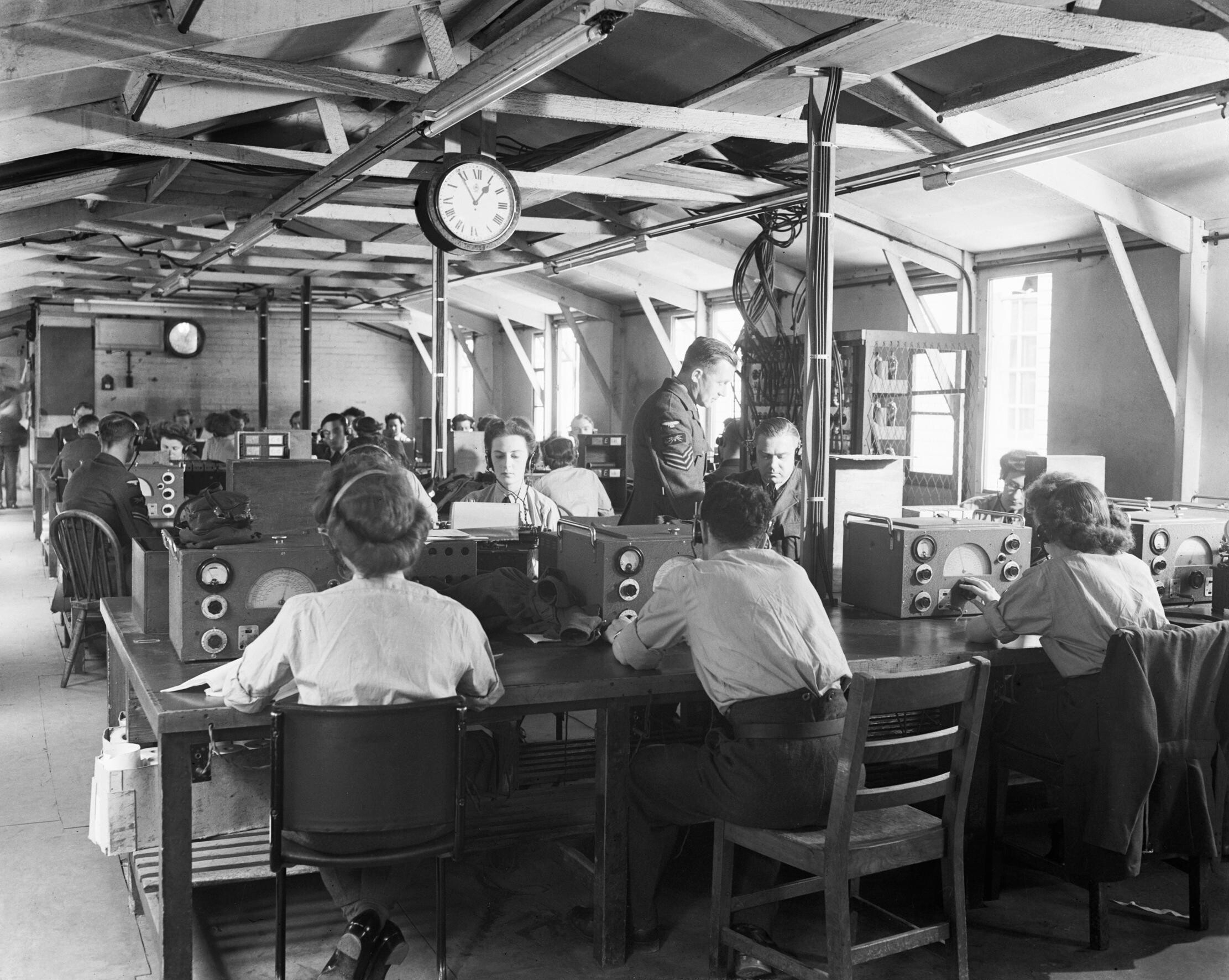 WAAF and RAF radio operators recording meteorological reports from aircraft and ships, Central Forecasting Station, Dunstable, Bedfordshire, England, United Kingdom, 1940s