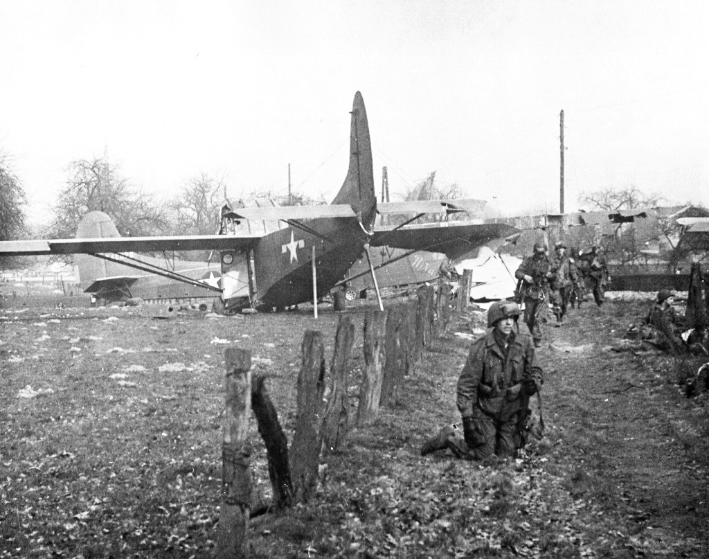CG-4A gliders on the ground after delivering troops near Wesel, Germany during Operation Varsity, 24 Mar 1945. Note the crutches holding up the glider’s tail to allow unloading heavy equipment through the open nose.
