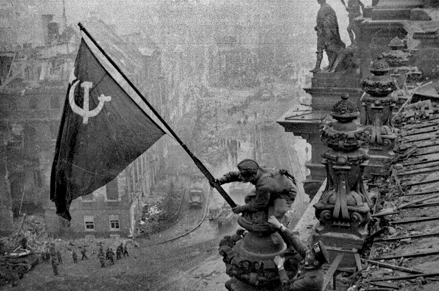 Red Army soldier Mikhail Alekseevich Yegorov of Soviet 756 Rifle Regiment flying the Soviet flag over the Reichstag, Berlin, Germany, 2 May 1945, photo 2 of 3