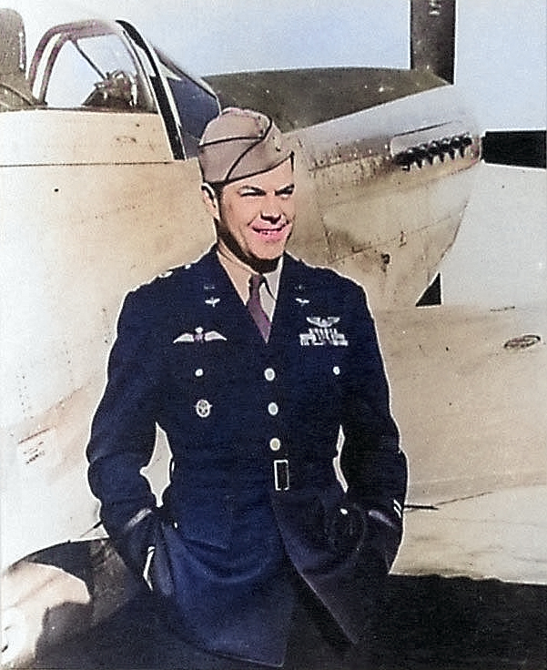 LtCol Bill Dunn in front of a P-51 Mustang. Dunn was the USA’s first fighter ace flying with the RAF Eagle Squadron before USA entered the war. Note his USAAF wings, RAF brevet, & what may be a Luftwaffe Pilot badge. [Colorized by WW2DB]