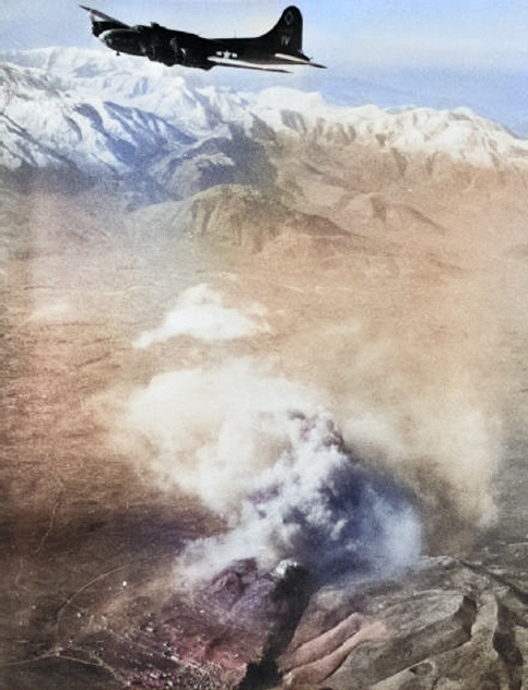 B-17F Fortress flying over Monte Cassino as smoke rises from the abbey, Feb 15, 1944. [Colorized by WW2DB]